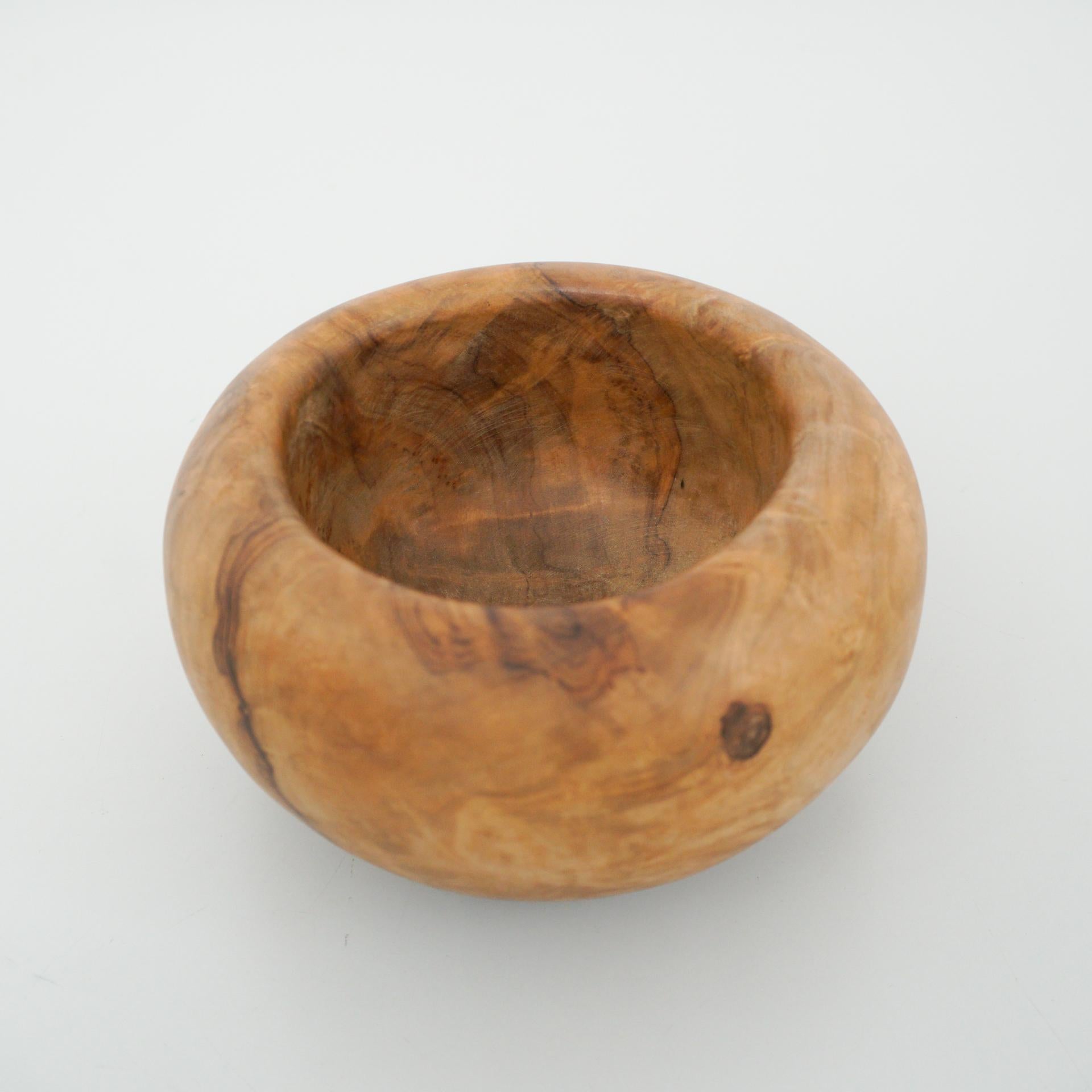 Embrace the charm and elegance of this authentic early 20th-century Spanish traditional olive wood bowl, meticulously crafted by an artisan. The natural beauty and character of the olive wood shine through in this piece, with a graceful patina that