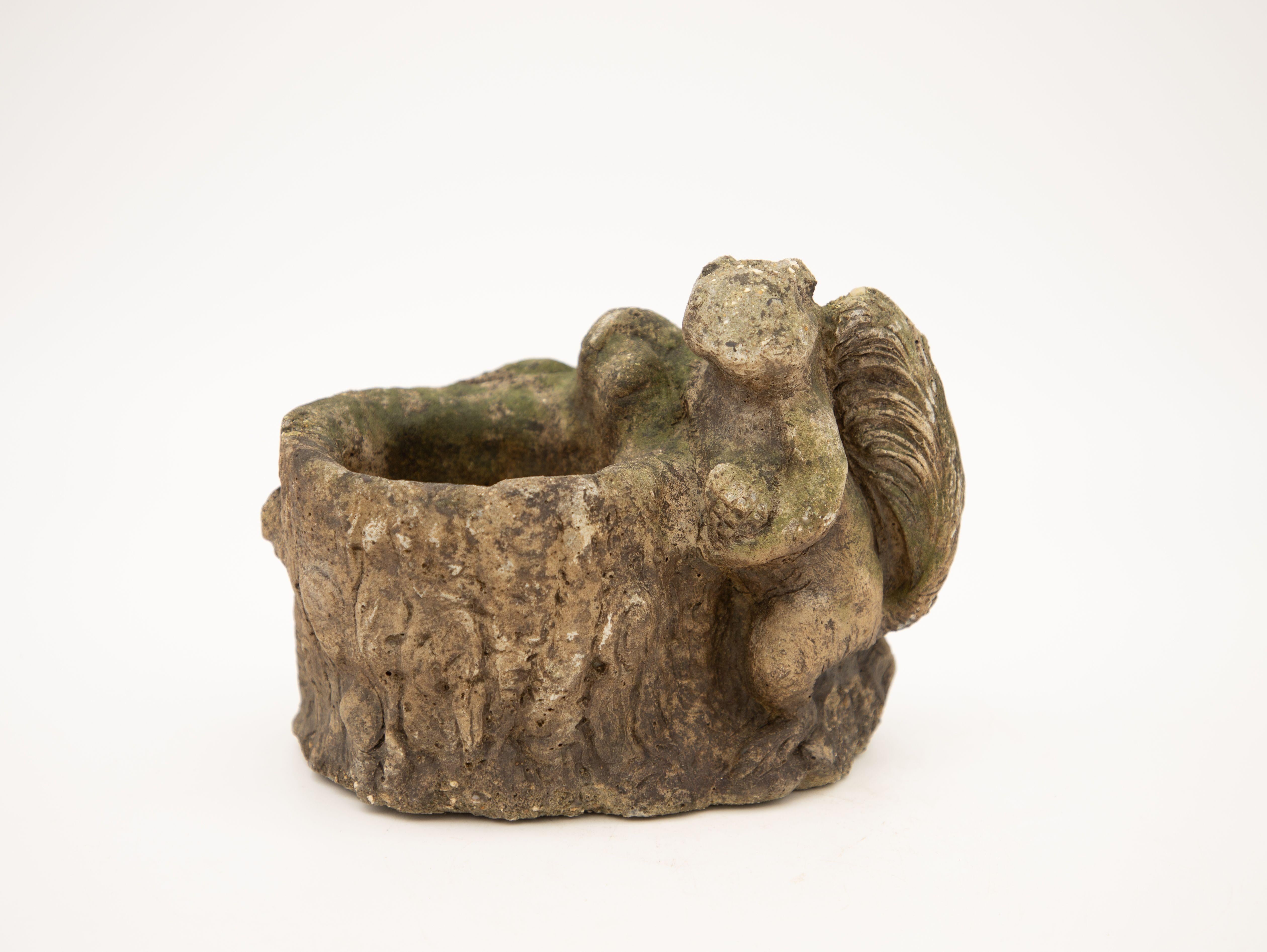 An early 20th century cast stone bird bath with a squirrel. Small in size and beautiful patina through honest age and use.