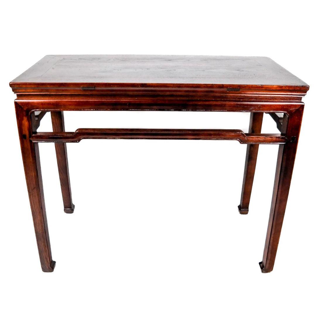 An early 20th Century Asian altar table of stained pine.  This beautifully designed table boasts  simple details with a slender, carved rail beneath the apron on all sides, and slender square legs that end on inverted hoof feet