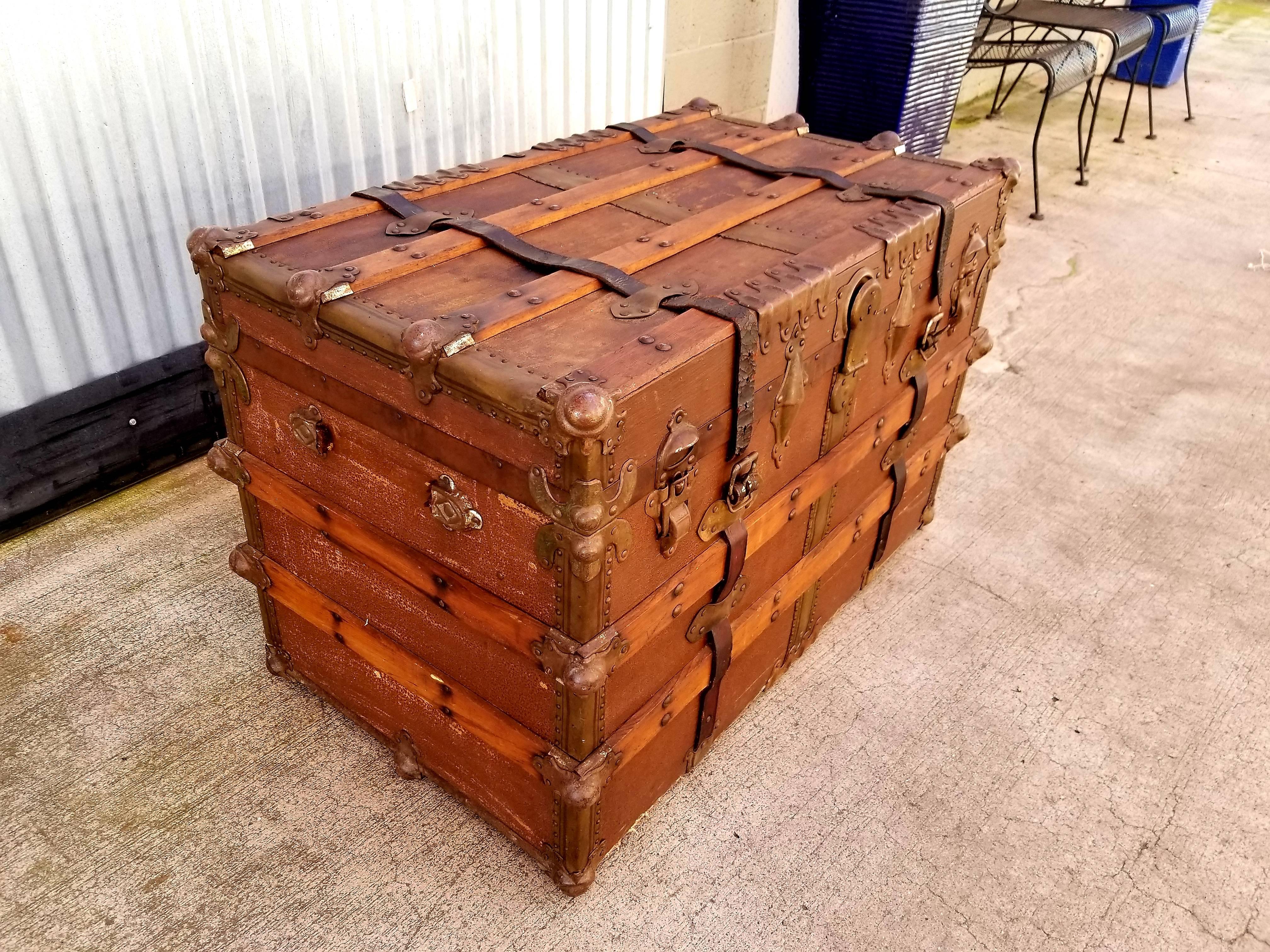 Early 20th century steamer trunk with beautiful patina to original finishes. Leather straps, steel mounts, canvas clad wood frame. Retains interior tray. Handsome piece with lots of character and old world, industrial charm.