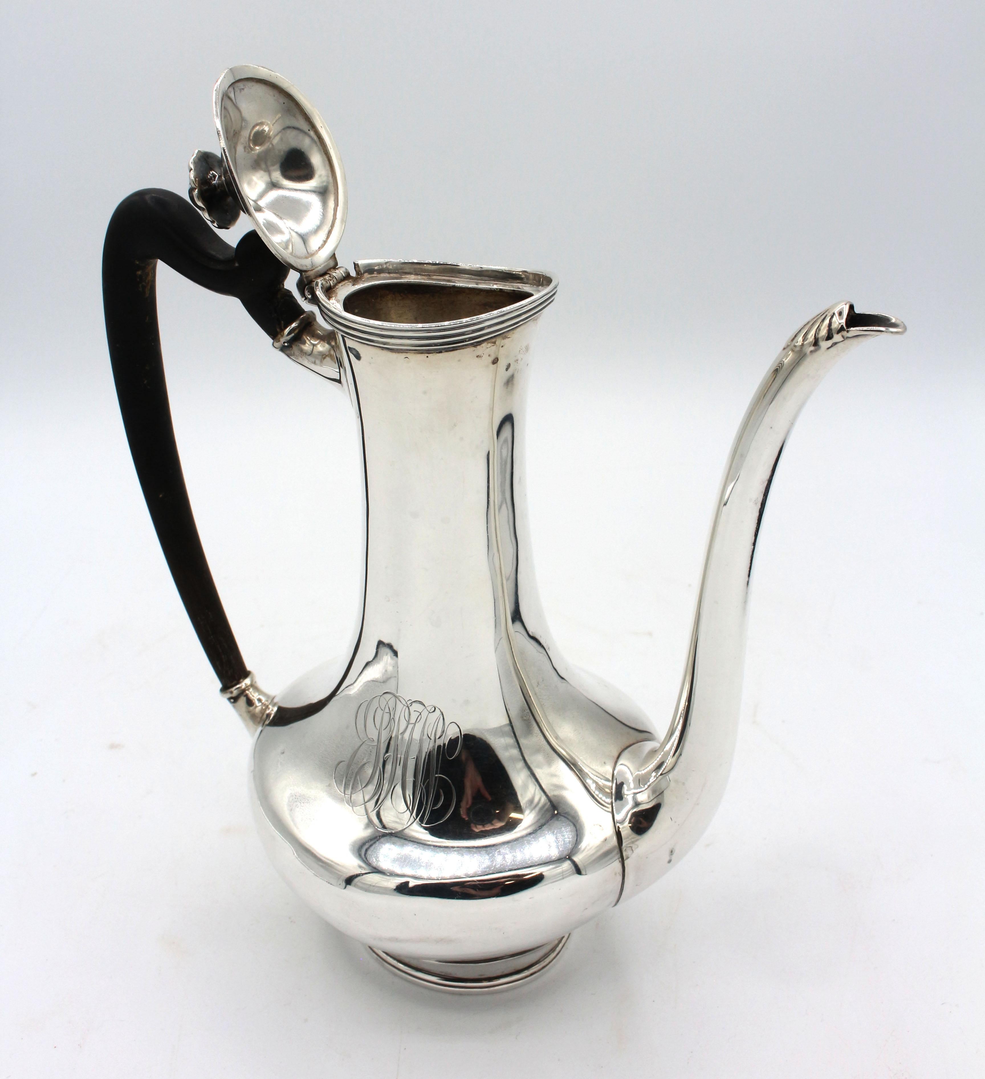 Sterling silver demitasse pot by Towle, early 20th century. Georgian taste. Retailed by Shreve, Crump & Lowe. Repaired ebony handle. Monogram. A few dimples. 12.20 troy oz.
7.75