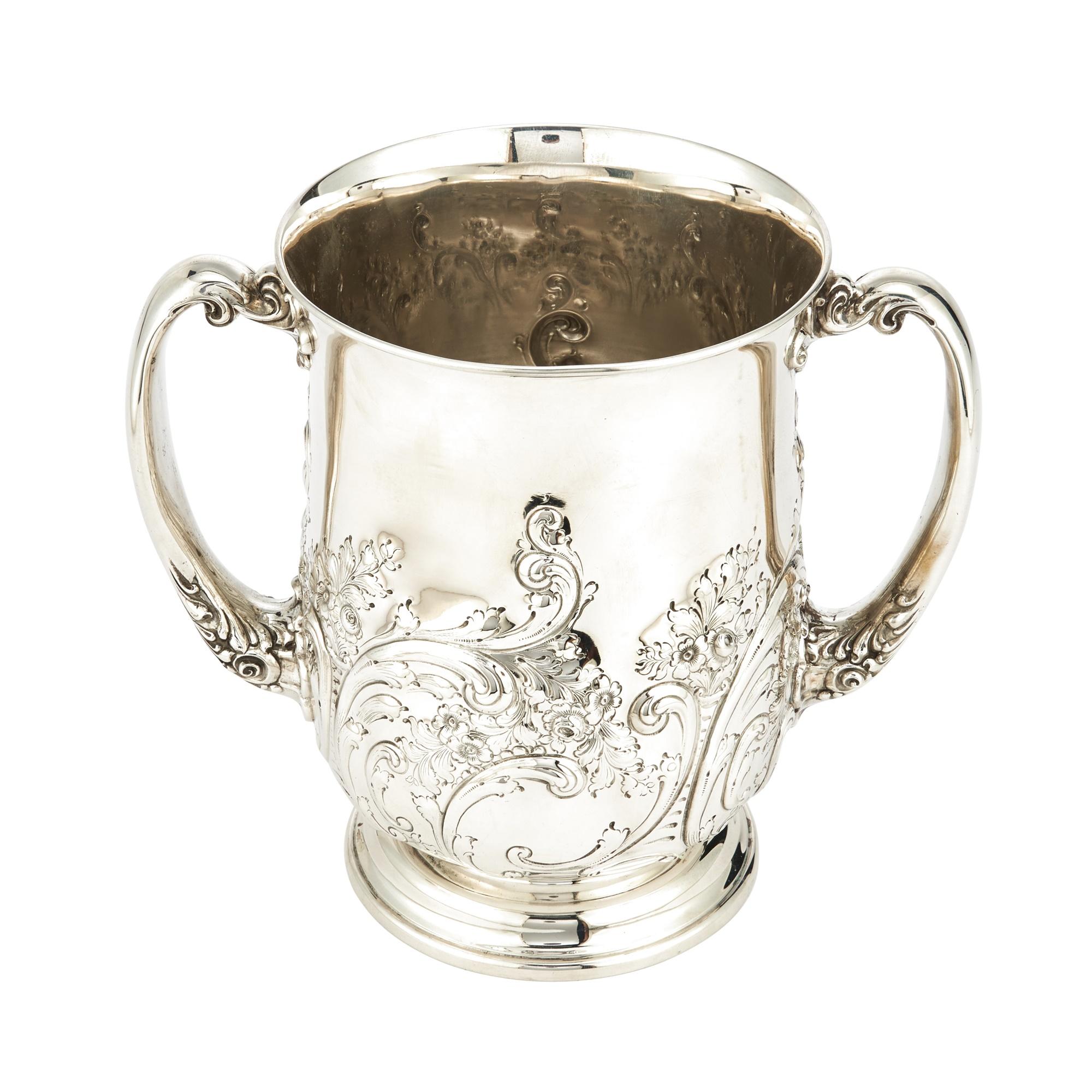 Introduce a touch of early 20th-century elegance to your collection with this sterling silver two-handled decorative piece/vase, crafted in the United States by Richards M Woods & Co. The piece boasts a luxurious gold-washed interior, adding a touch