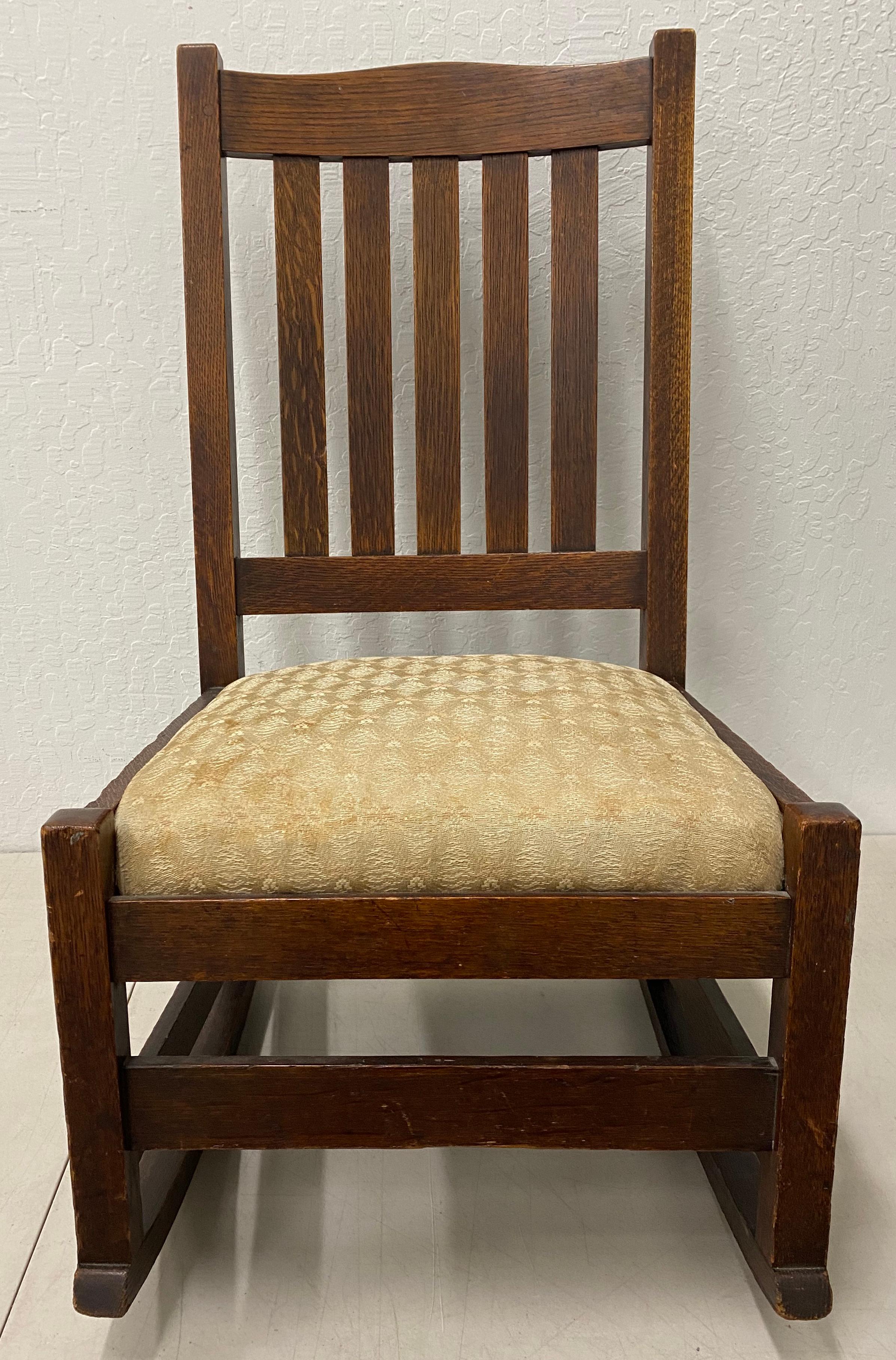 Early 20th century Stickley mission oak rocking chair, circa 1910

Solid and comfortable chair. Easily remove seat (unscrew) to replace the fabric.

Dimensions 18