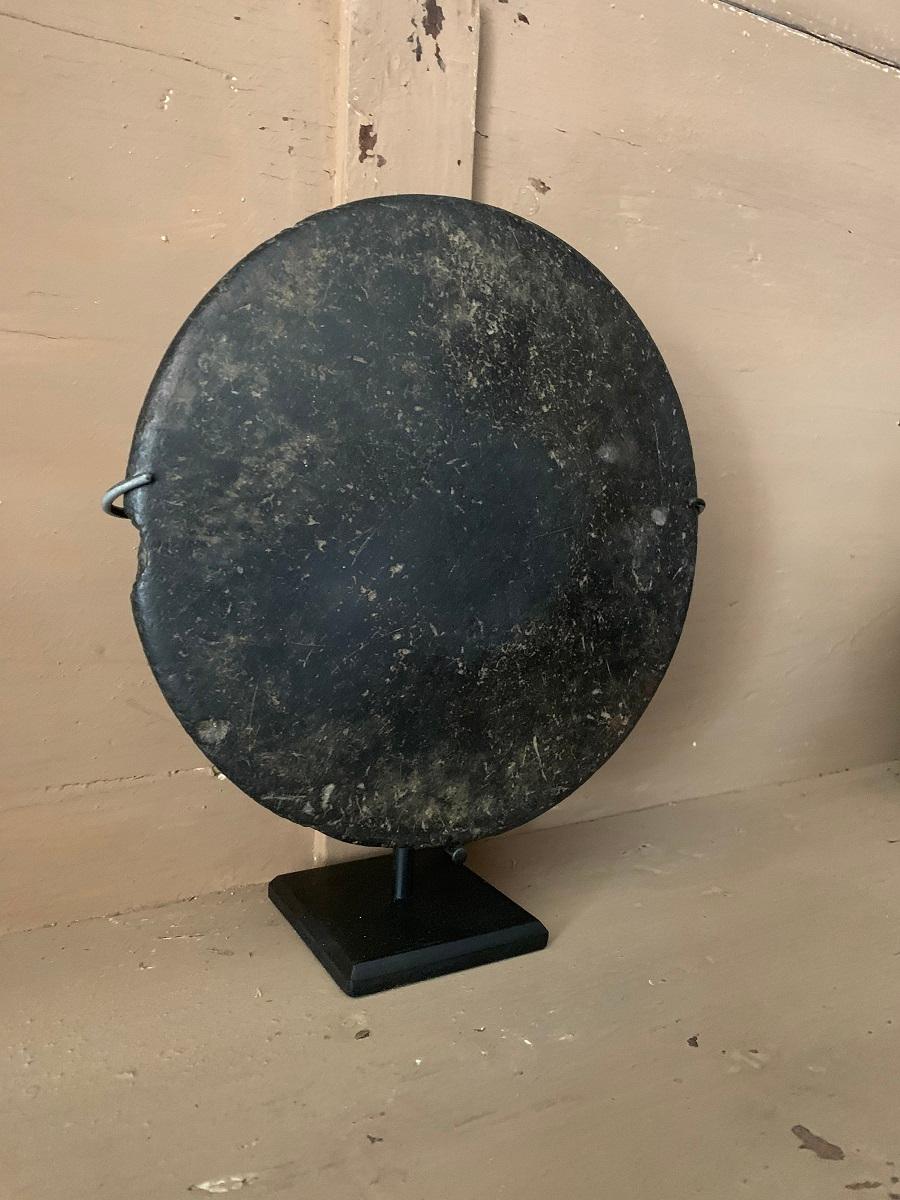 A polished hardstone disc. Provenance unknown but probably a early 20th century Hawaiin Ulu Maika stoen. Ulu Maika is a ancient game simular to bowling played by the indigineaous Hawaiin people.
This disc is quite intriguing with its lovely patina