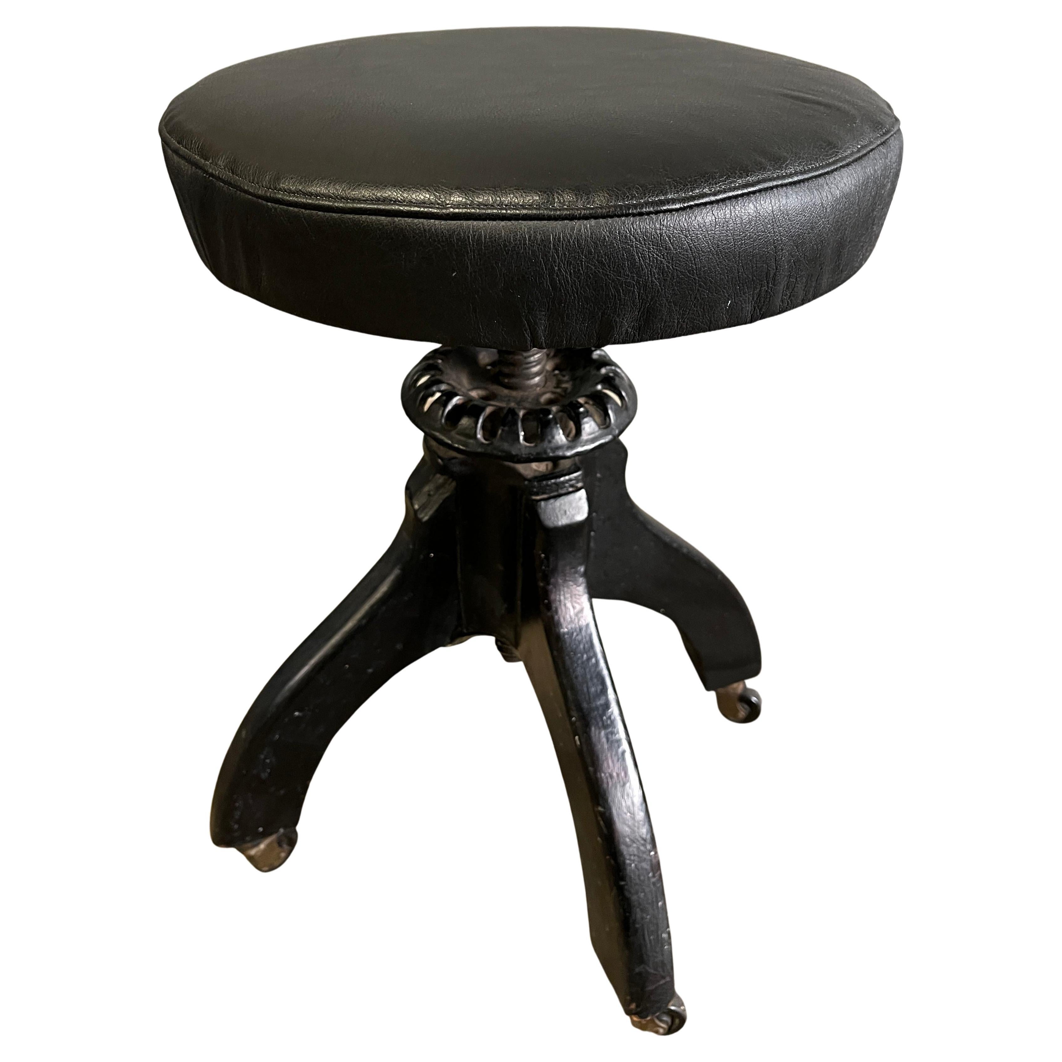 Wonderful hand made three legged stool with adjustable height ( 16.5-23'' )

Painted black wood legs with cast iron elements. The top has a newer leather top. Fits with Midcentury Modern and more antique designs. 

