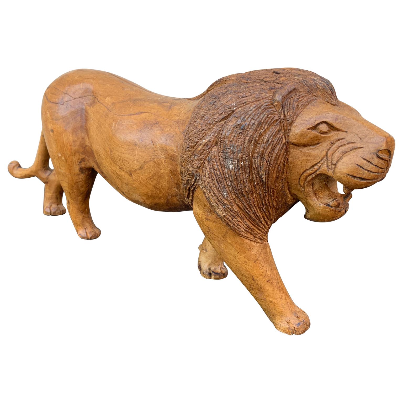An Scandinavian wooden sculpture of a lion, hand made and painted in the early 1900's.