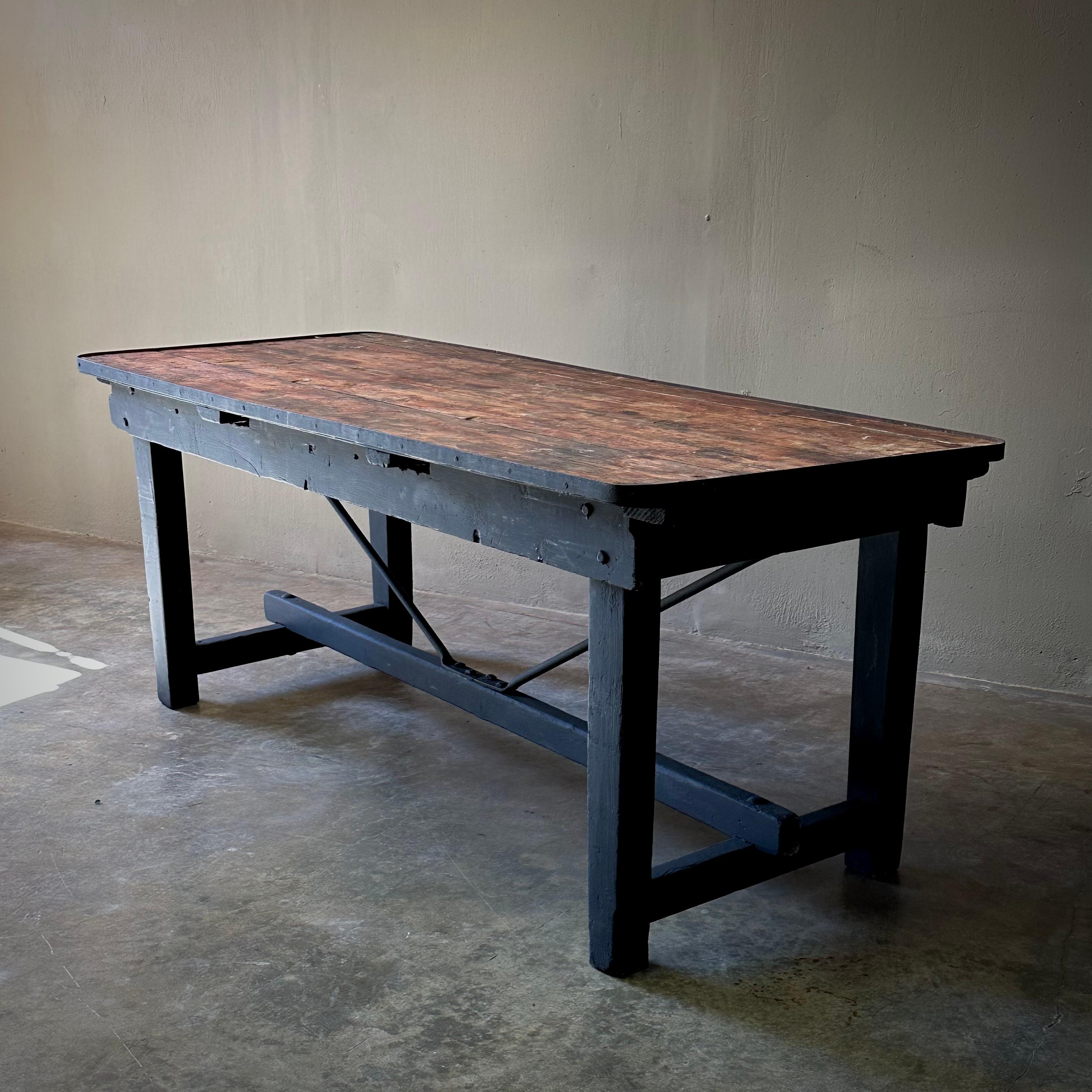 Early 20th century Swedish industrial table with wood top and black painted wood base. A versatile piece with strong, simple lines and a rustic utilitarian feel. Would work well in both indoor and outdoor spaces alike, especially as a buffet or