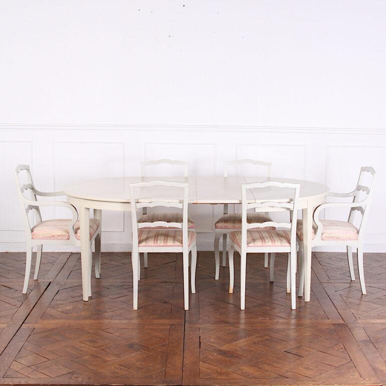 A vintage round Swedish painted dining table with two extra leaves. This simple table stands on elegant square tapering legs and extends with two leaves to seat 8 people. Available with matching set of Swedish painted chairs as shown.