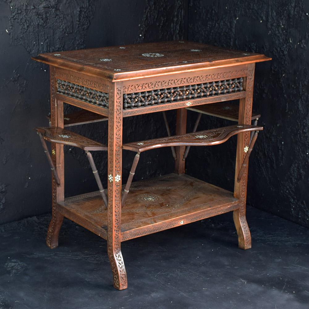 Early 20th Century Syrian Folding Side Table

A highly decorative and functional example of an early 20th century Syrian folding side table. With ornate hand carved detail and geometric inlaid sections as shown. Likely to have been used to serve