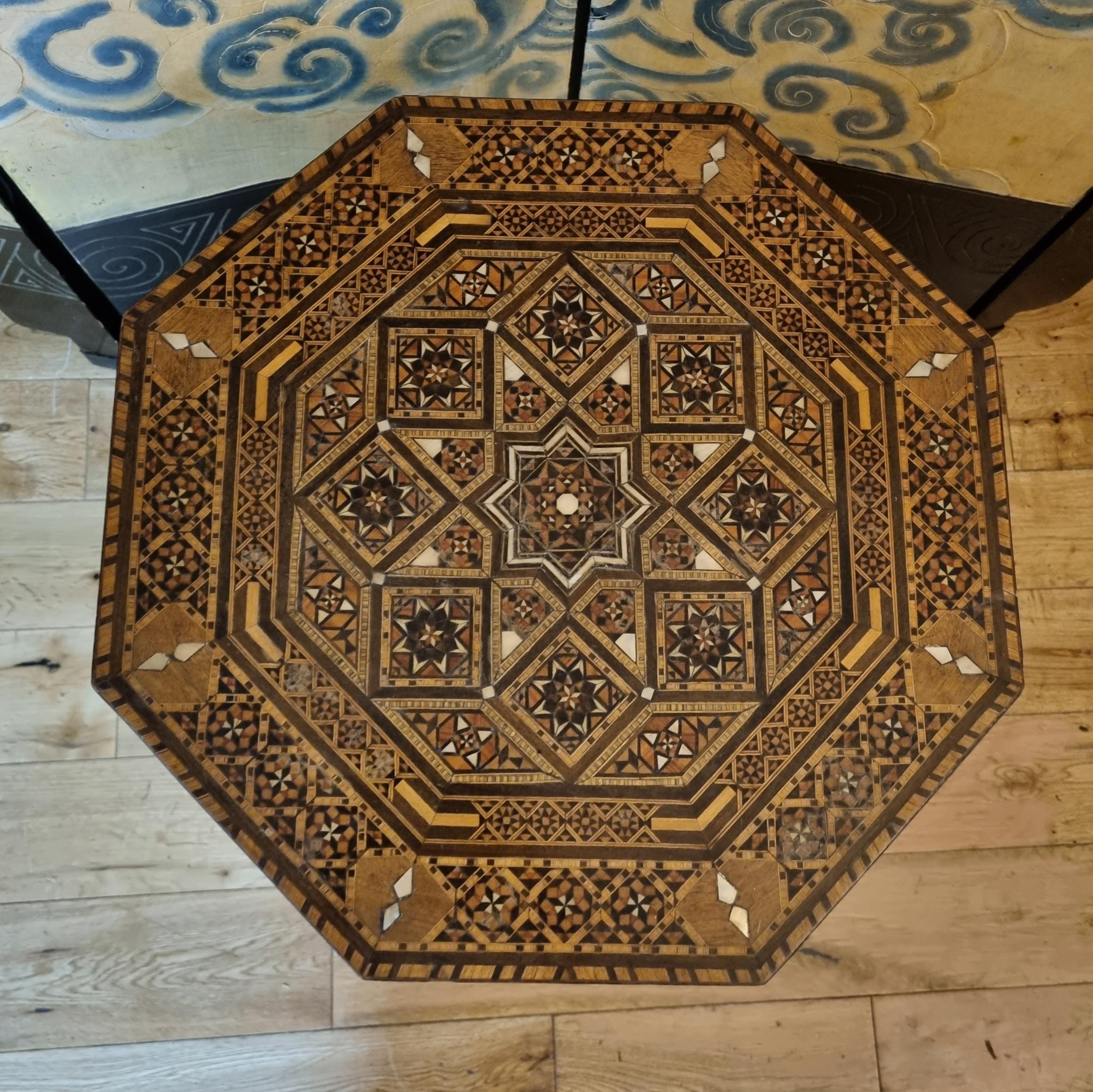 A finely crafted Syrian octagonal side table dating to circa 1920, featuring elaborate marquetry inlay in traditional Levantine geometric designs. Constructed from a variety of hardwoods with mother of pearl inlays, this piece exemplifies Syrian