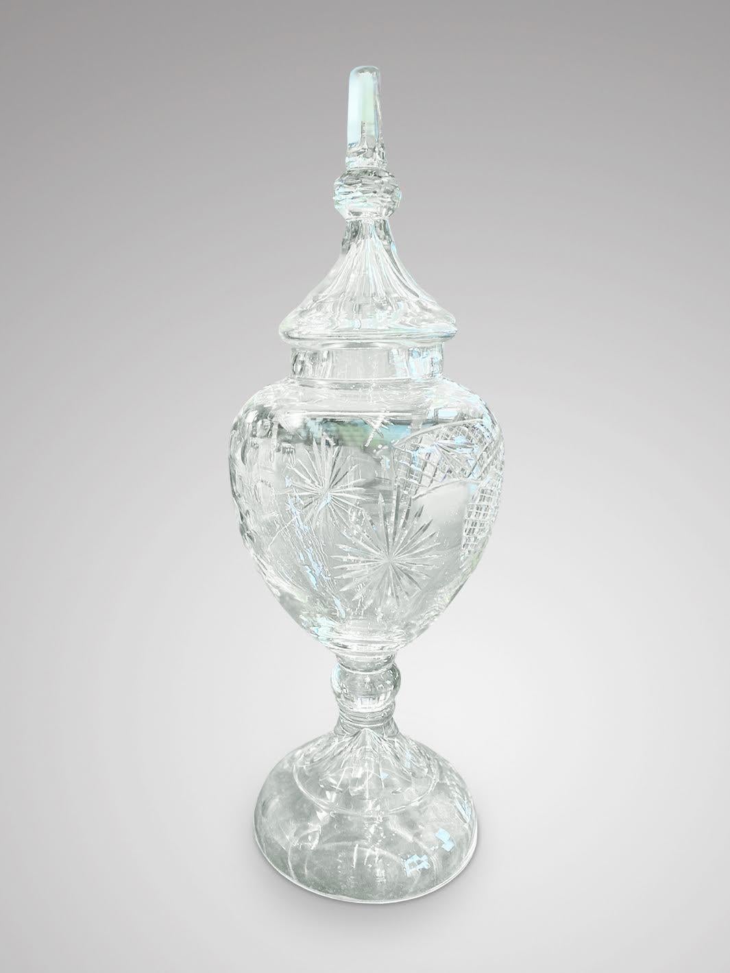 An impressive early 20th century tall cut glass apothecary vase with original cover. All in perfect original condition.

The dimensions are:
Height: 95cm (37.4in)
Diameter: 27cm (10.6in)

The tall cut glass vase is in good antique condition