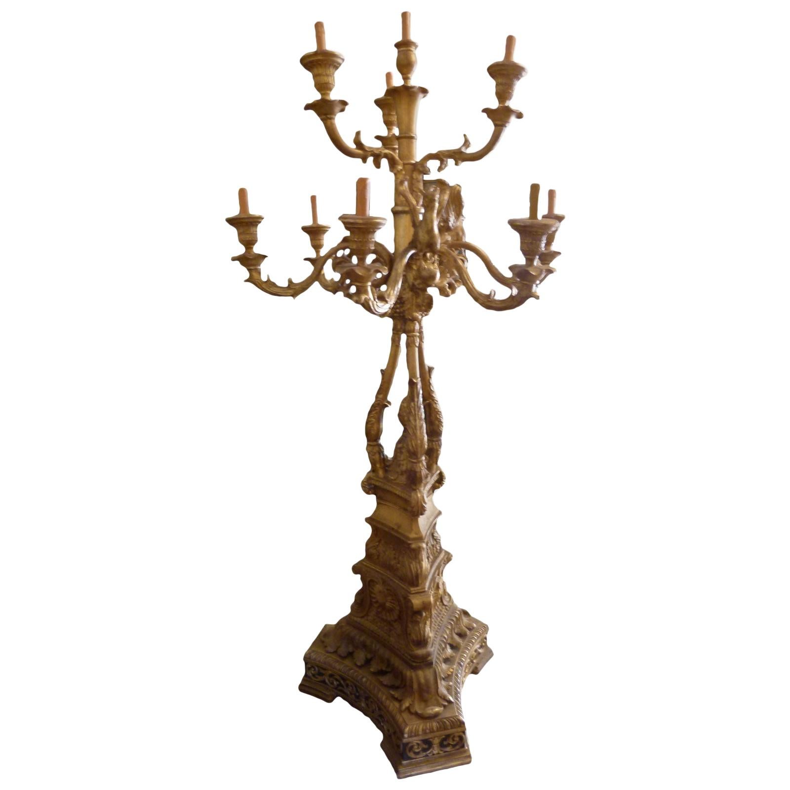 Tall standing candelabra. Gold patinated. Hand carved wood. Square base with 10 arms in two different levels.