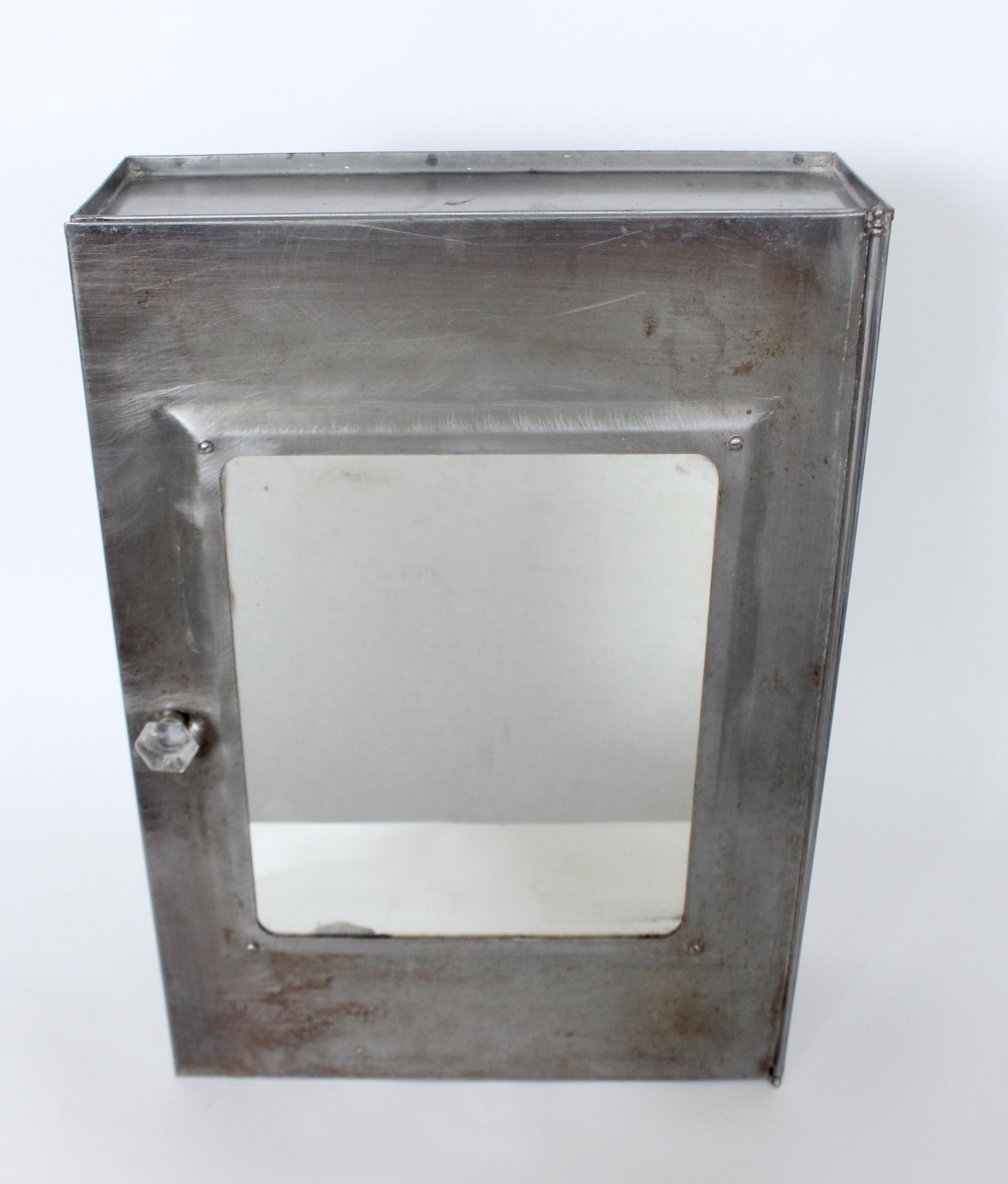 Original Early 20th Century Three Shelf Metal & Glass Front Medicine Cabinet.  Featuring a tall and slender rectangular Metal cabinet with 3 fixed metal shelves, (shelf distances: Top: 4.5H clearance, Middle: 5.5