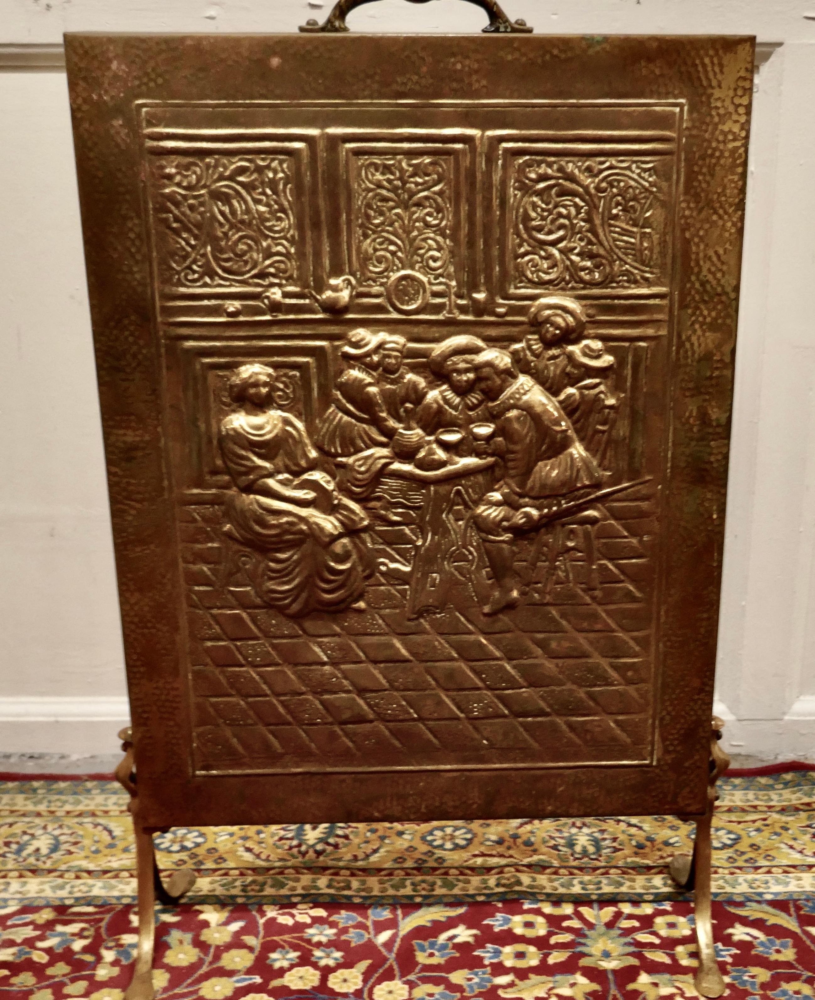 Early 20th century tavern scene brass fire screen

This is an attractive fire screen it pictures a 19th century tavern.
The screen is good quality and made in brass with a handle to the top.
The screen is in good condition.
The screen is 18”