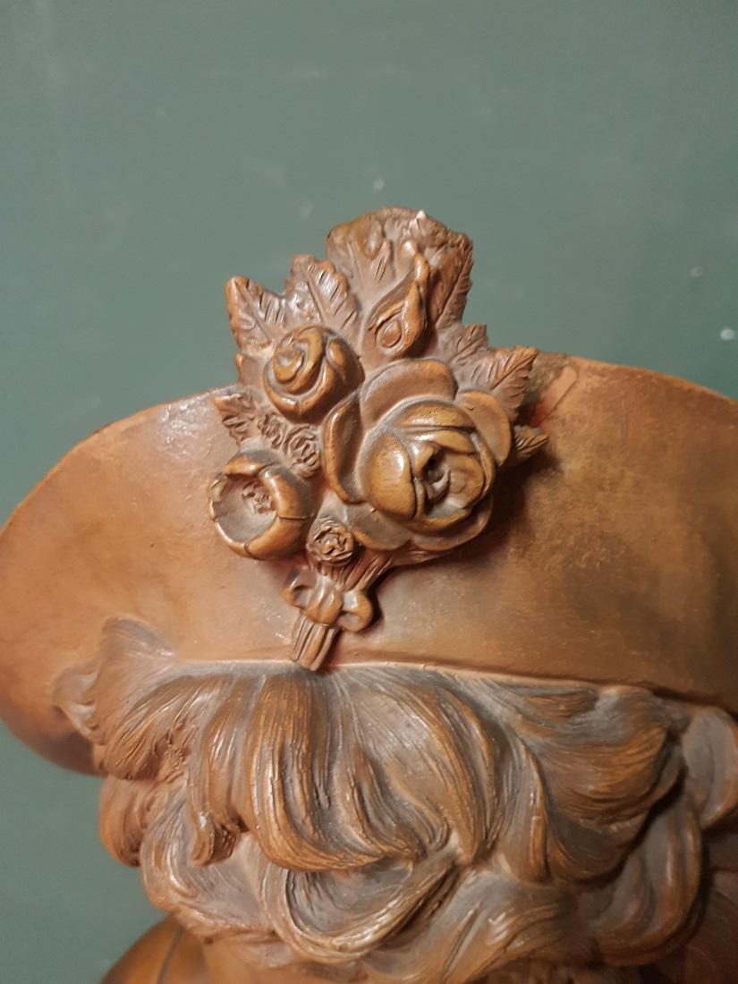 European Early 20th Century Terracotta Bust of an Elegant Young Lady with a Hat For Sale