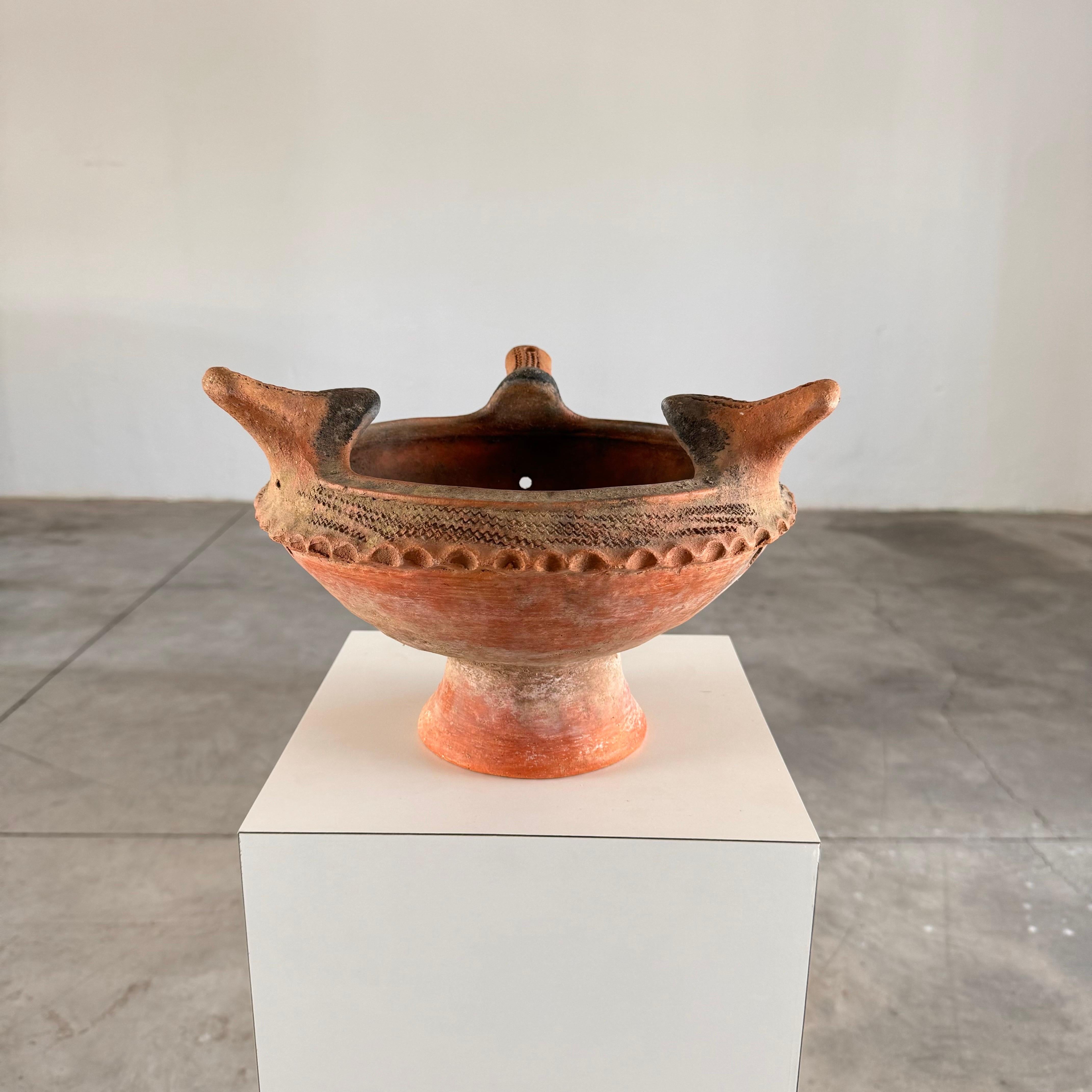 This exquisite early 20th-century Italian terracotta piece serves as a versatile planter, centerpiece, vase, or brazier. Despite its age, it is in excellent condition, boasting a rich patina that adds a charming, lived-in quality while maintaining a