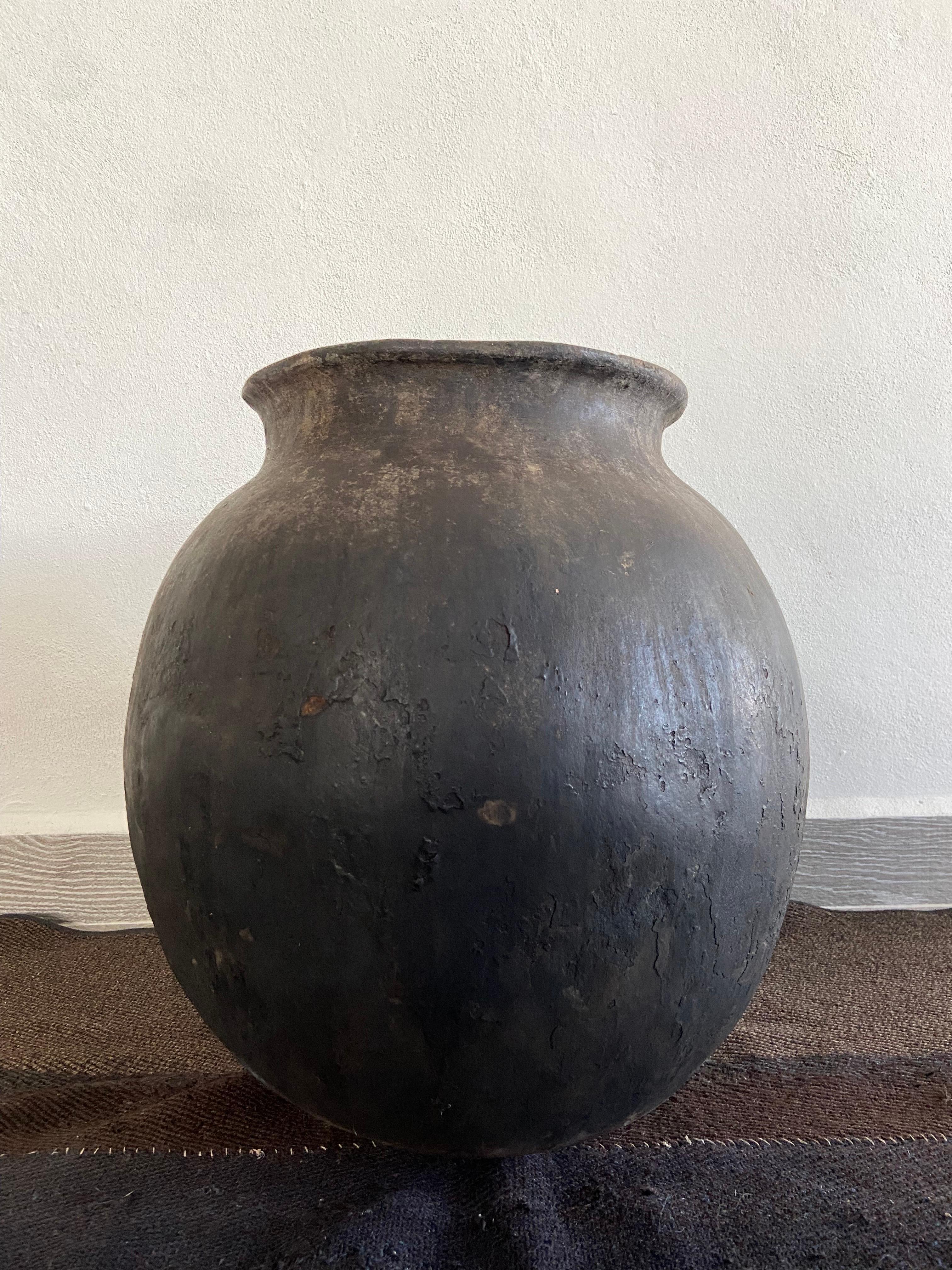Early 20th century terracotta water jar from the high sierras of Michoacan, Mexico. The pot has an original repair on the bottom area as shown on the photos, however it was carried out very well.