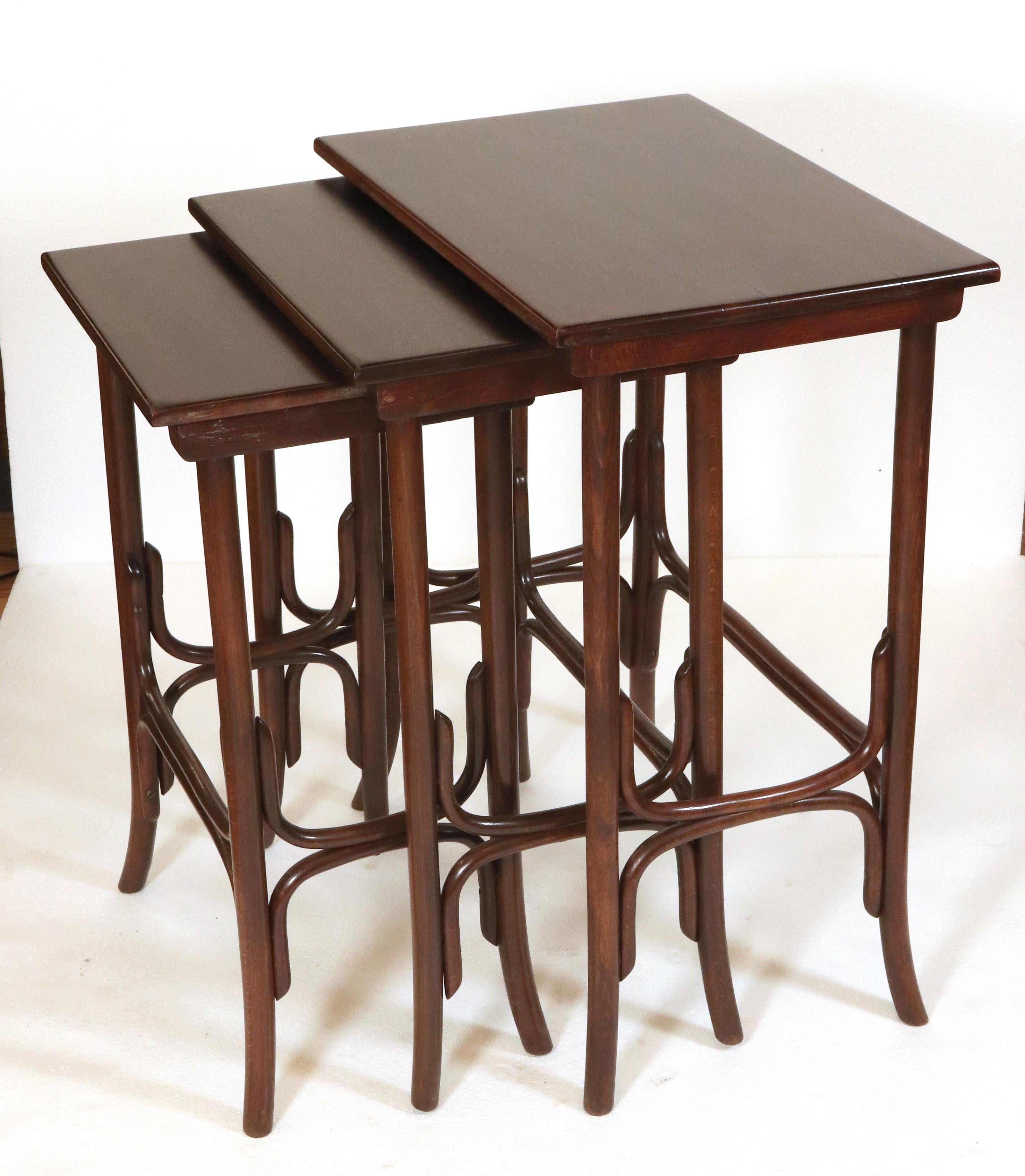 Mid 20th Century set of nesting tables made of dark stained bentwood oak wood. Made by Thonet. Good, restored condition. Priced as a set of three. Please note, this item is located in our NYC location.