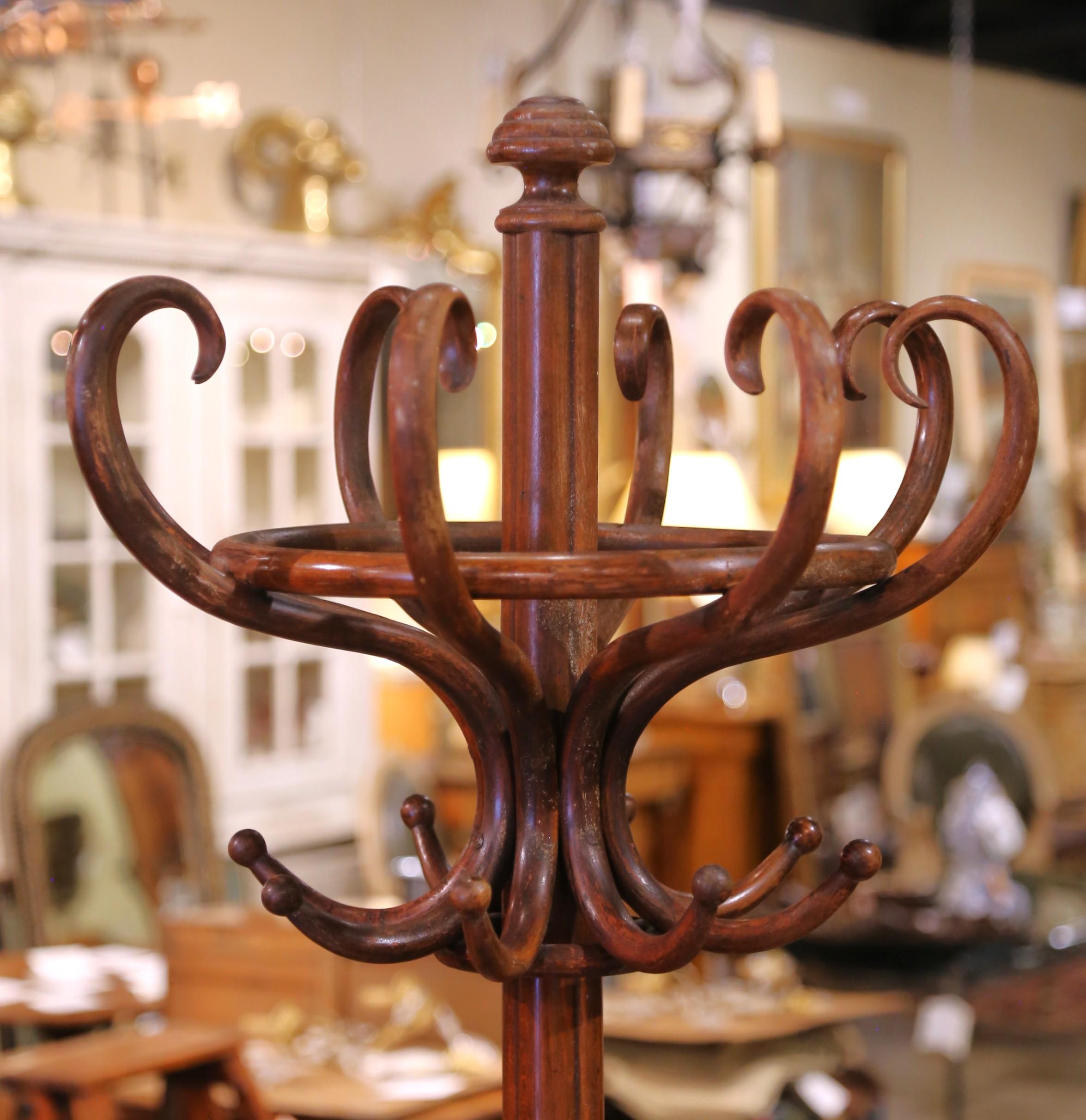 Crafted in France circa 1920, this graceful antique hall tree is executed in the style of German-Austrian cabinetmaker Michael Thonet (1796–1871), known for his mastery of steam-bent woodwork. Made from richly patinated beechwood, the unique piece