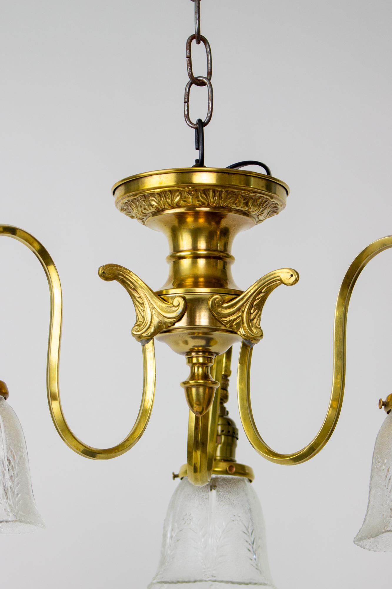 Early 20th century three light prismatic semi flush fixture. Brass ceiling plate with three curved arms. Original prismatic glass shades. Early 20th Century. American. In good condition, with some old repairs to the brass. rewired and ready for