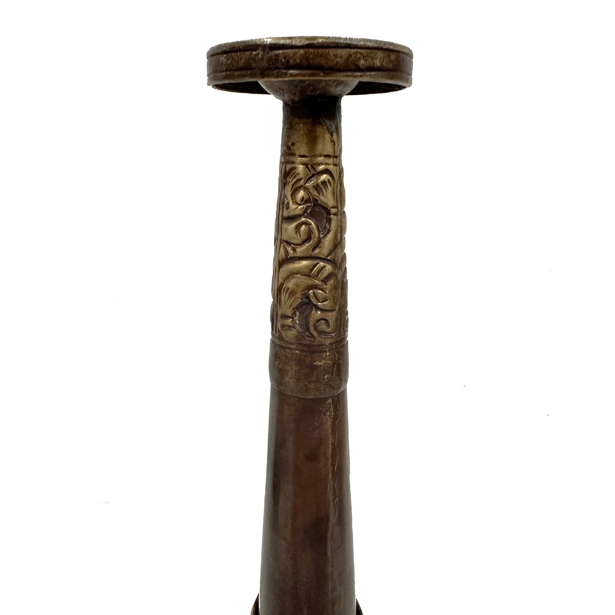 This is a Rag-Dung, also known as a Dungchen or Tibetan long trumpet, a significant wind instrument used in Tibetan Buddhist ceremonies. It was crafted from copper and brass with some decorative stone beads, the Rag-Dung is characterized by its