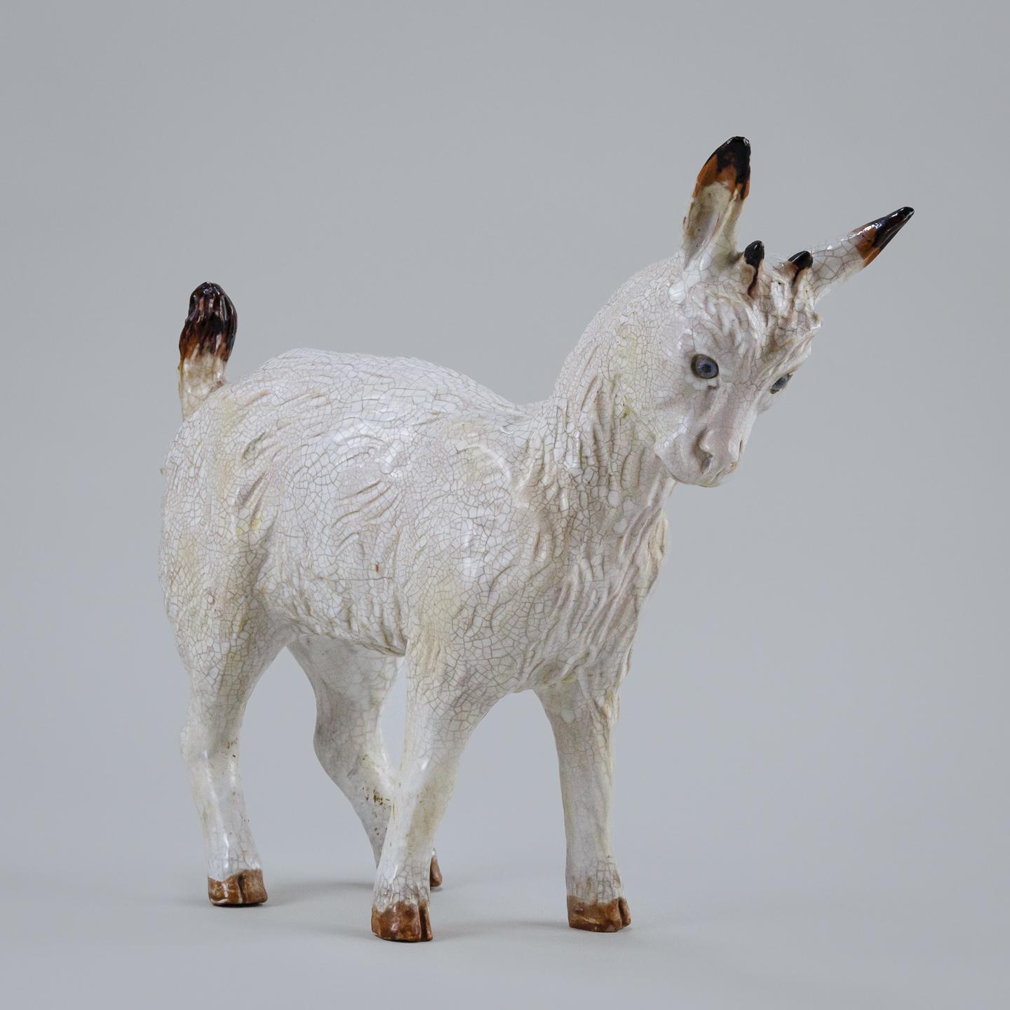 Impressive and amusing lifesized Pygmy goat, made by Tuilerie du Mesnil de Bavent commonly referred to just as Bavent. Wonderful used condition with expected craquelure to the glaze and minor nibbles. Glass eyes. France Circa 1920 Tuilerie du Mesnil