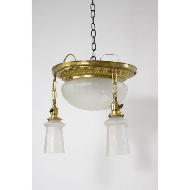 Flush mount pan light with three down hanging lights. Original iridescent glass globe and bell shaped hanging glass shades. 

Material: glass, brass
Style: Traditional
Place of origin: United States
Period made: early 20th century
Dimensions: