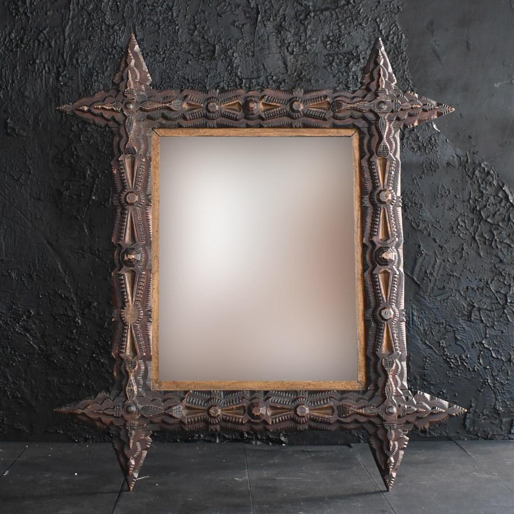 Early 20th Century Tramp Art Mirror  
A highly decorative example of an early 20th century EU tramp art mirror. Some of tramp art's defining characteristics include chip or notch carving, the reclamation of cheap or available wood such as that from