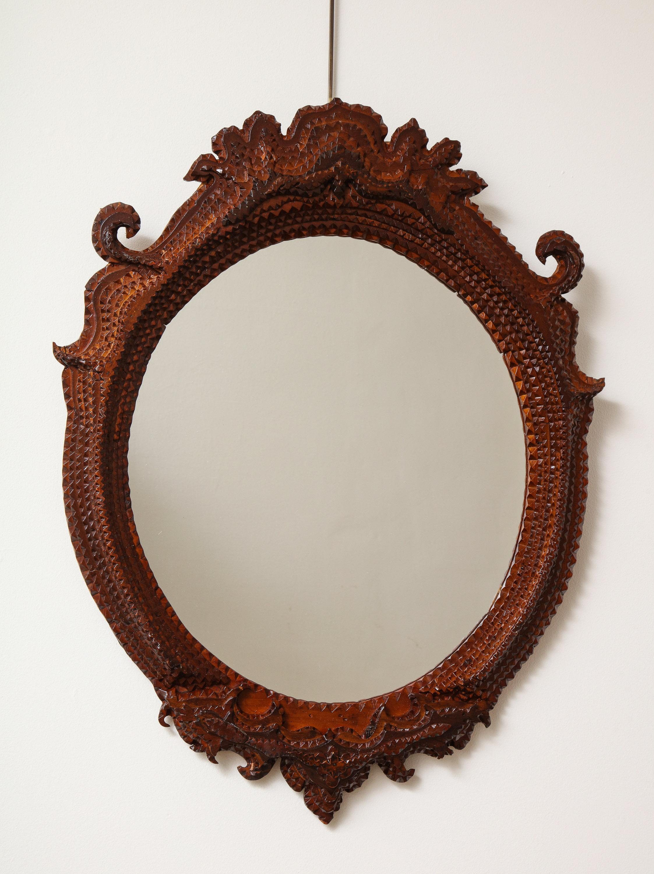 Early 20th century, carved tramp art mirror.