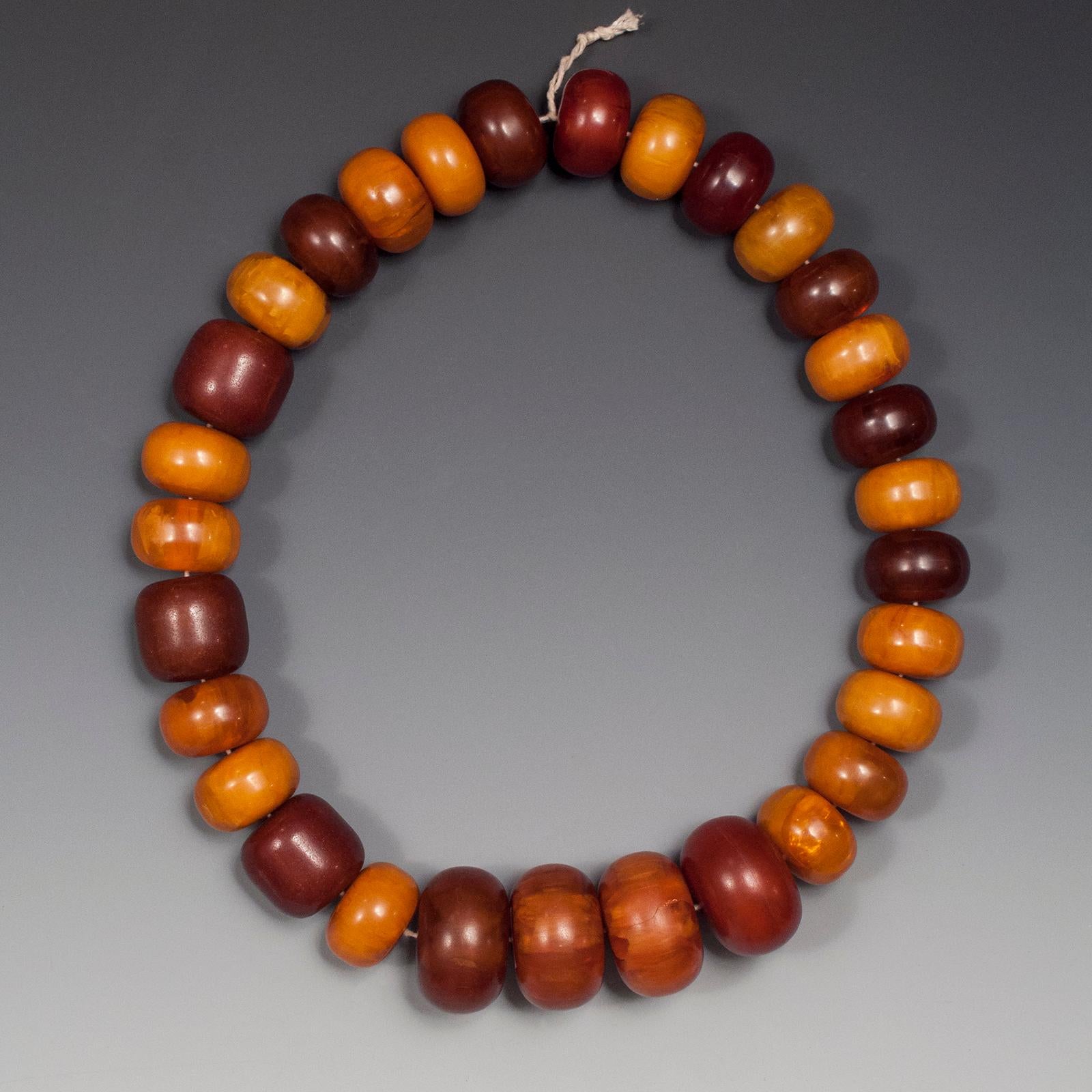 Early 20th century tribal Bakelite amber beads from Africa.

These beads are referred to as African amber and were made in Europe, likely Germany, of phenolic resin or Bakelite. This is a nice strand of 30 beads from a private Nevada collection
