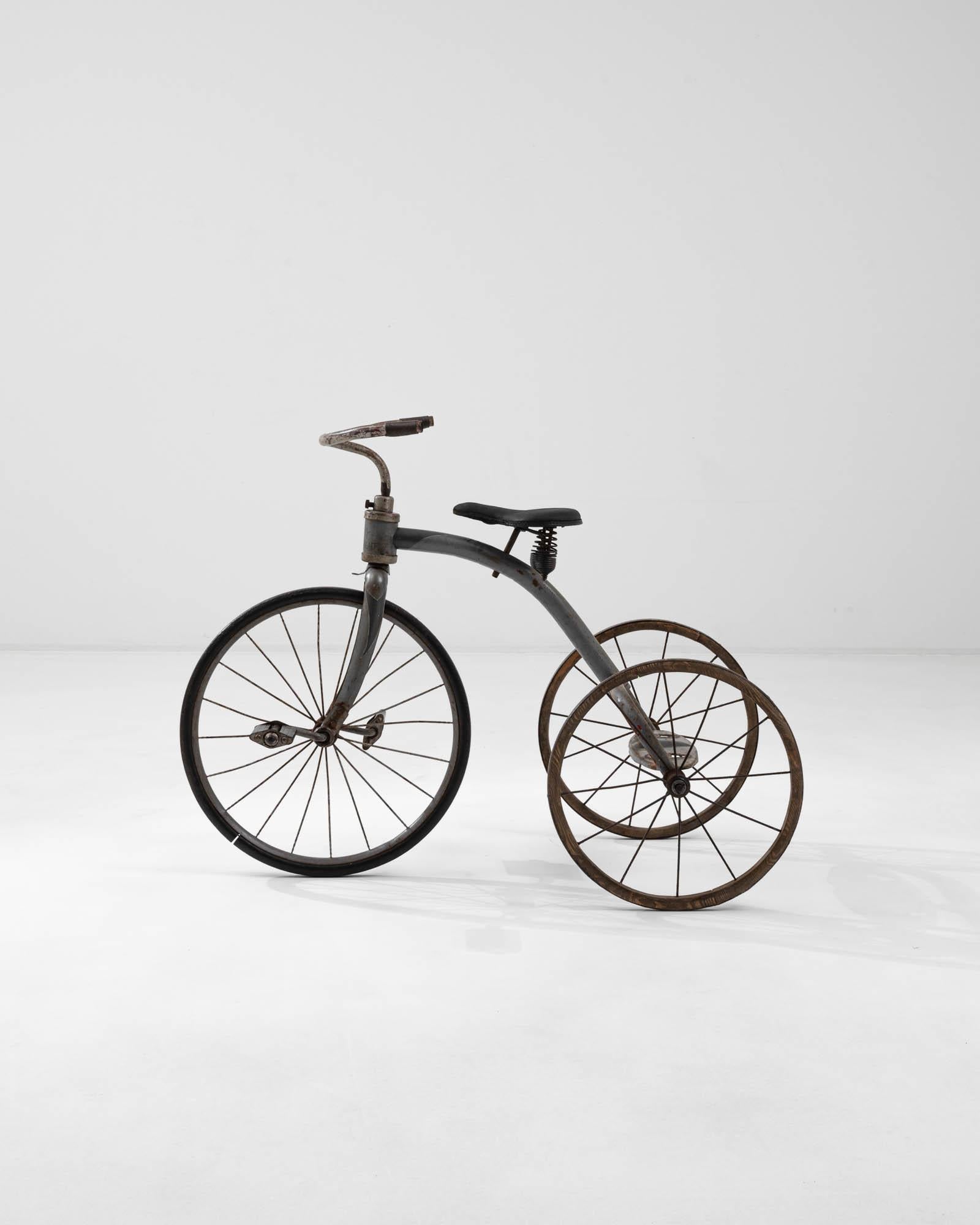Originating from early 20th-century Central Europe, this tricycle stands as a fascinating relic that offers a window into transportation trends of its time. Distinguished by its robust construction and innovative design, it features a large front