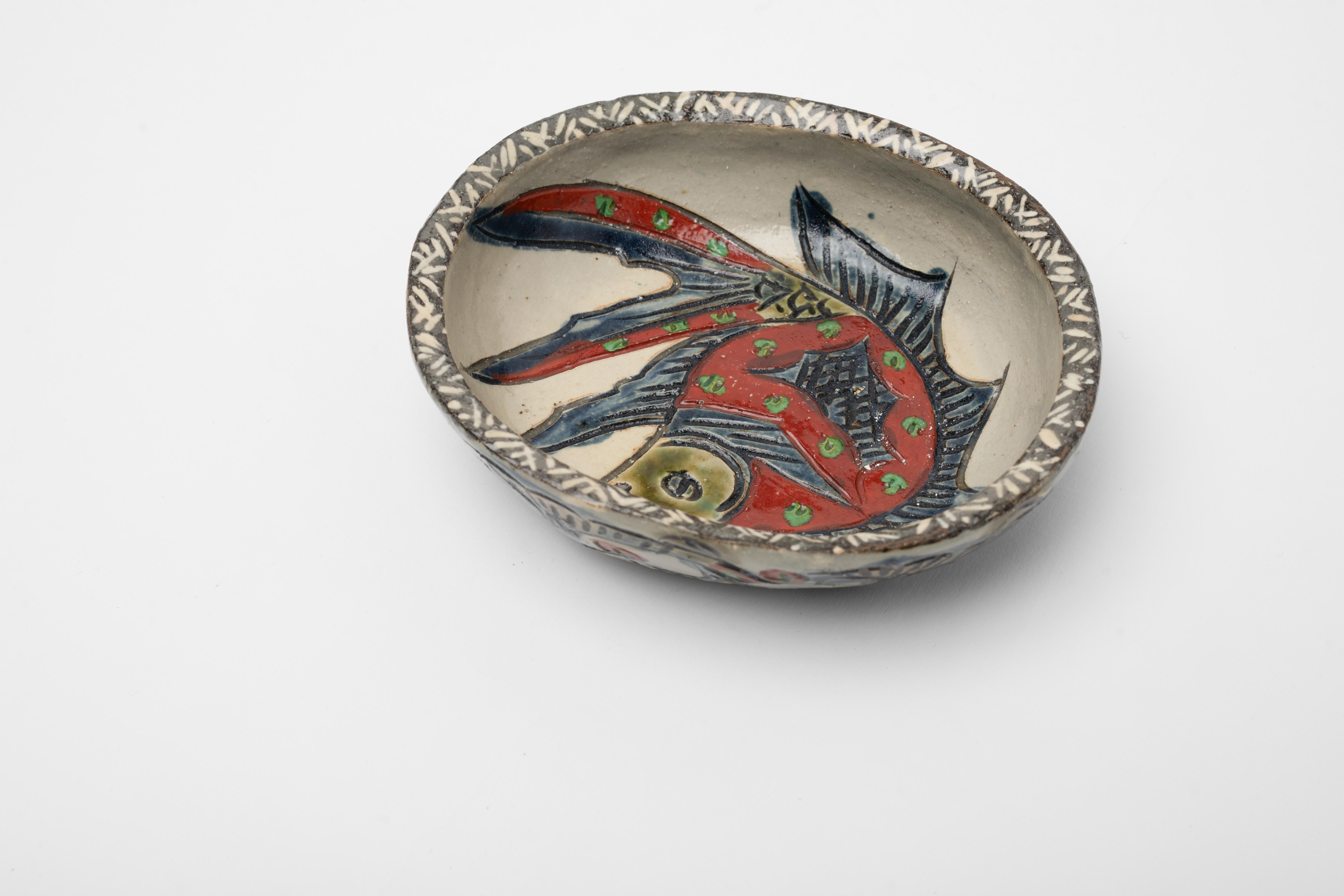 Incredible piece of Tsuboya-yaki or Tsuboya ware which comes from the Okinawa region of Japan. Most likely from the Taisho period (1912-1926) when there was a resurgence of popularity of Tsuboya-yaki folk craft ware.

The icon of the angel fish is