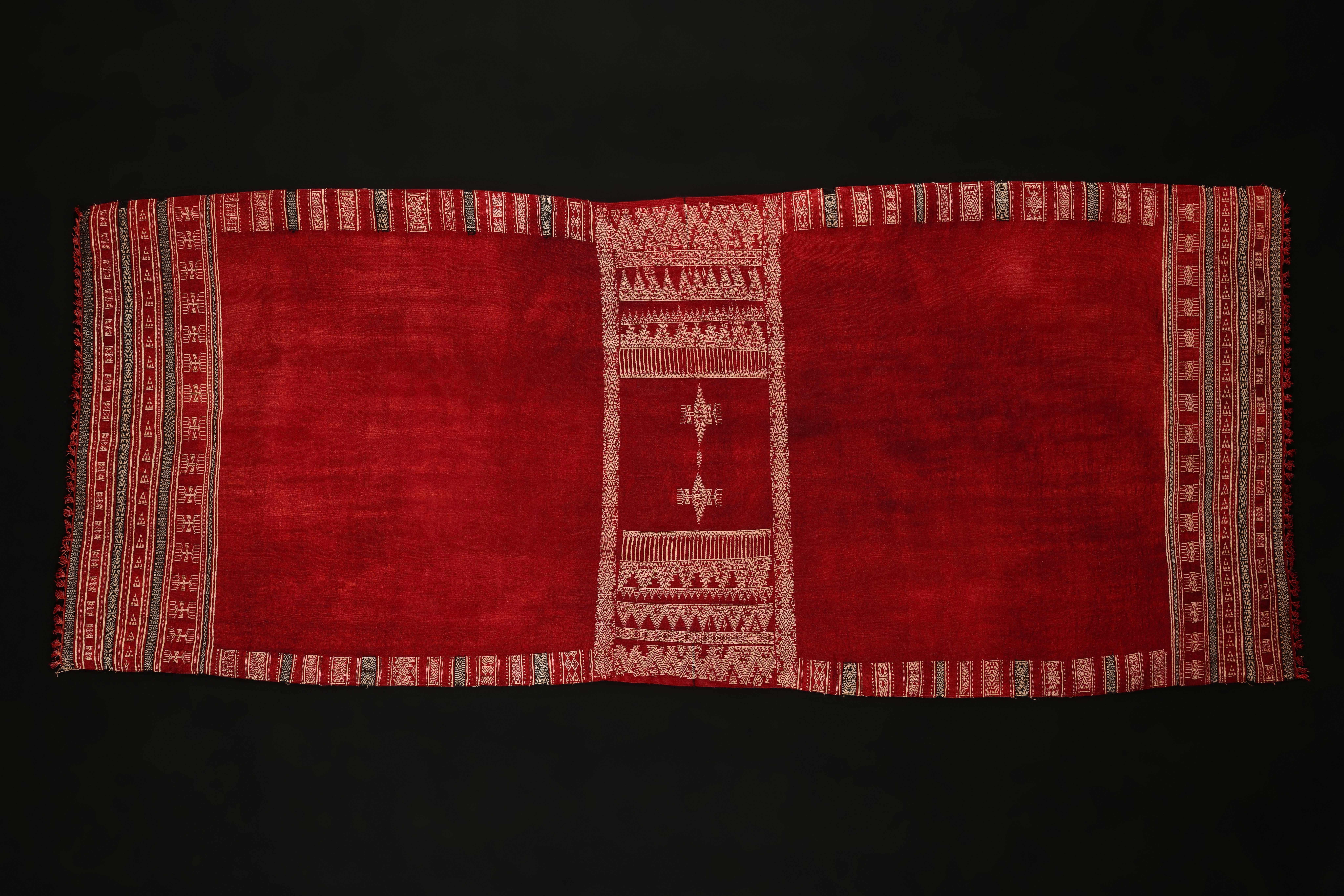 Woman’s Cover, Bakhnouk
Berber people, Matmata Mountains, Tunisia
Early 20th century
Wool, cotton, natural and synthetic dyes (?)  Supplementary patterning
Dyed after being woven which creates the rich variagated tones of crimson red.
The cotton