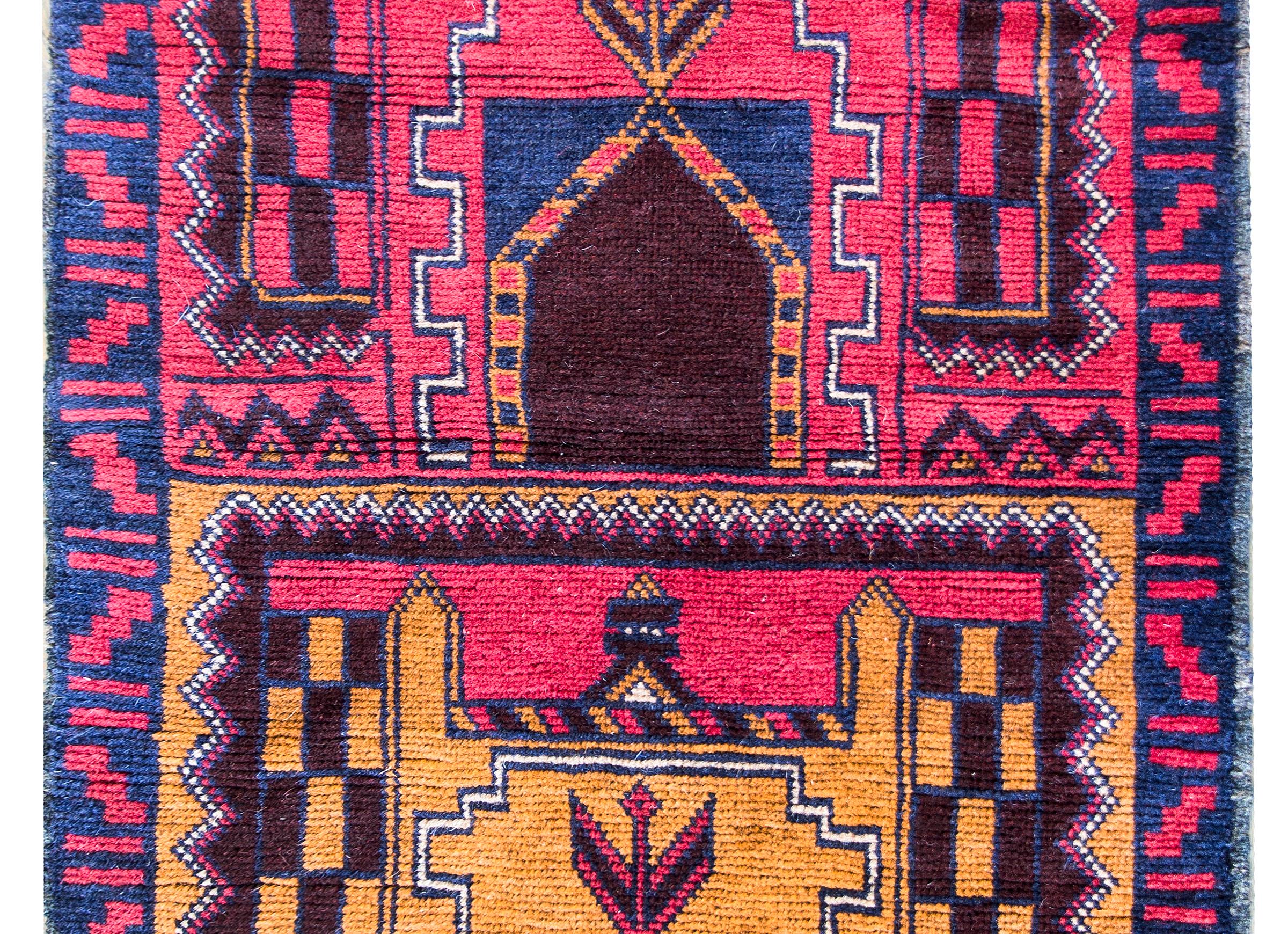 A beautiful early 20th century Turkish Konya Prayer rug with two architectural-style images woven in bright crimsons, golds, violets, and indigos, and surrounded by a beautiful geometric pattered border.