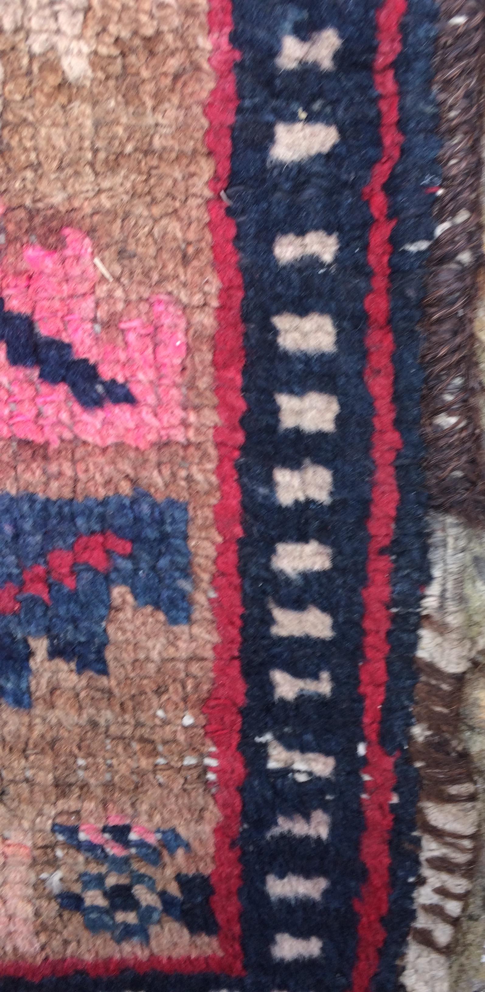 Decorative area rug with very vivid colors that is in semi distressed condition consistent with age.

Minor imperfections consistent with age and use (see detailed photos).

Rendered in variegated shades of red, blue, beige, pale pink. Perfect