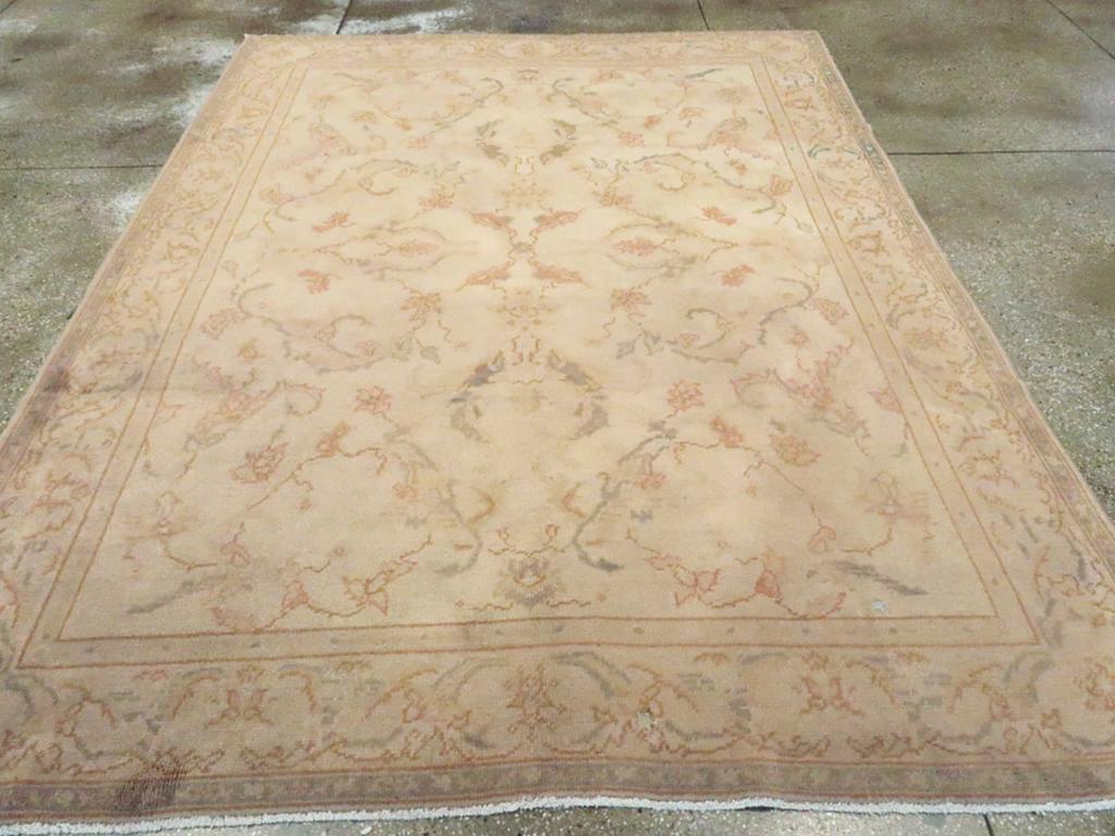 An antique Turkish Oushak accent carpet. Leaves, leaves everywhere, but few flowers, on the lightest tan ground of this centrally organized western Turkish workshop rug. The  brown-accented leaves faintly resemble acanthus and are very well spaced