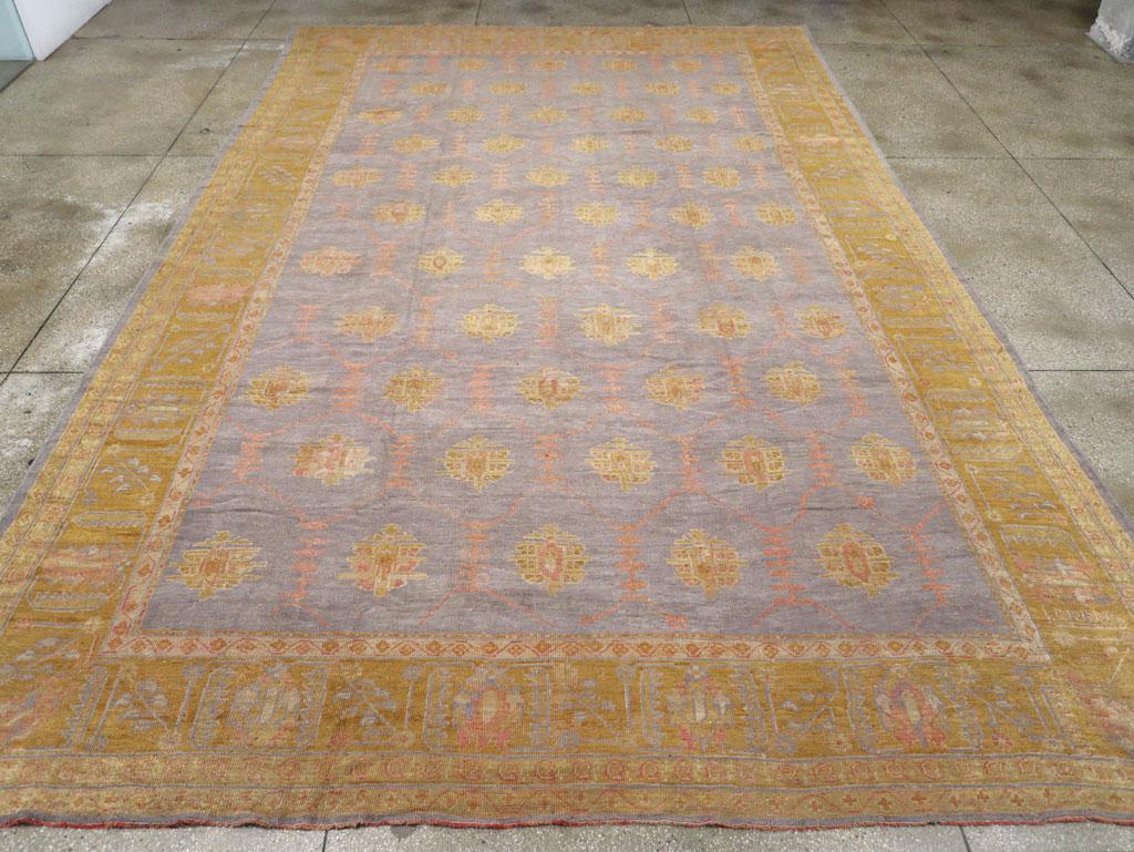 This wool pile, with symmetric knots on a wool foundation, features an unusual and highly desirable pale blue field that hosts eleven offset rows of well-spaced palmettes, connected by a vestigial straight vinery. The palmettes are accented with