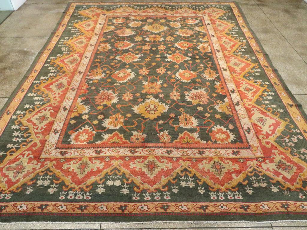 An antique Turkish Oushak large carpet handmade during the Early 20th century.

Measures: 12' 9