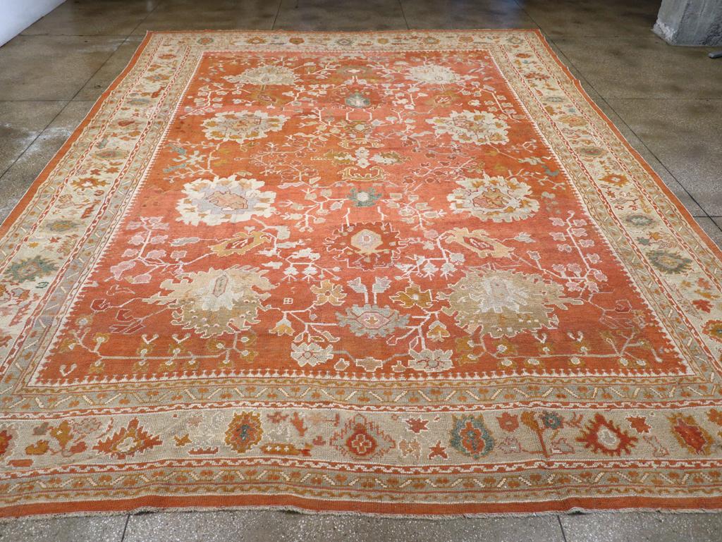 An antique Turkish Oushak large carpet handmade during the Early 20th century.

Measures: 13' 2