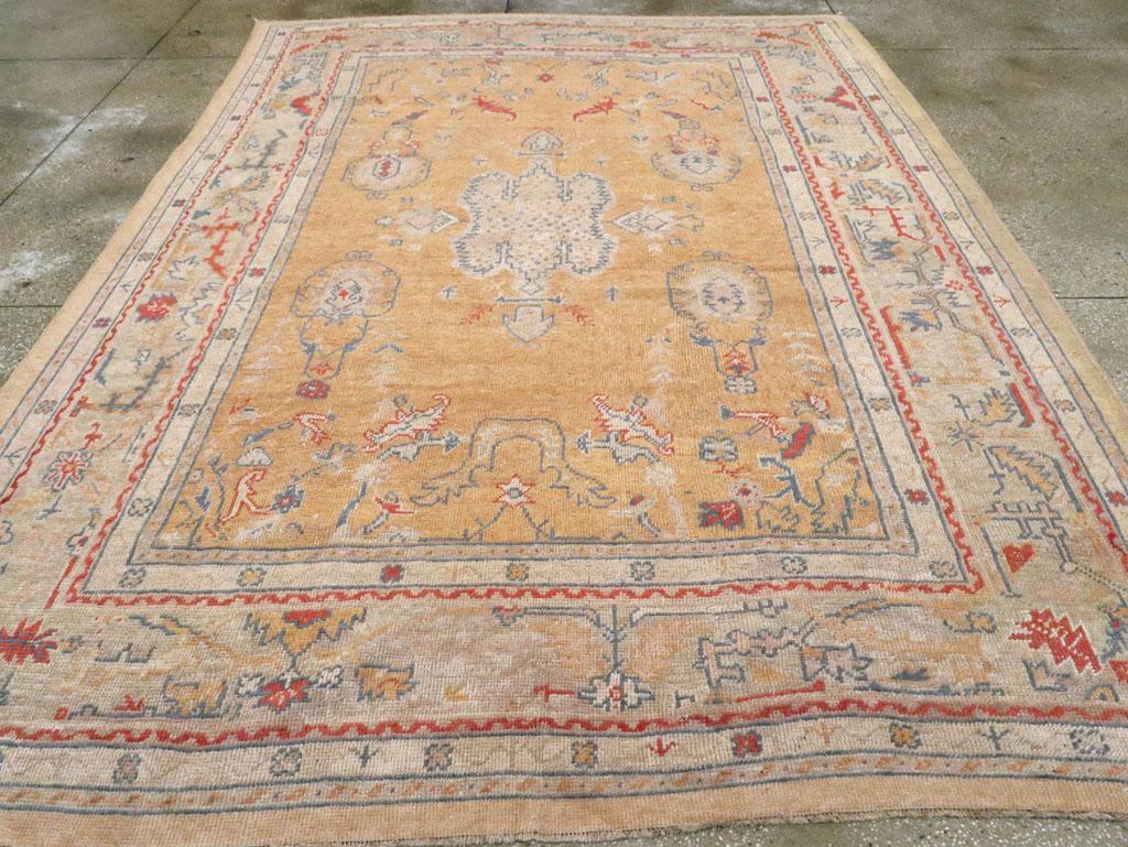 An antique Turkish Oushak room size carpet handmade during the Early 20th century.

Measures: 8' 5