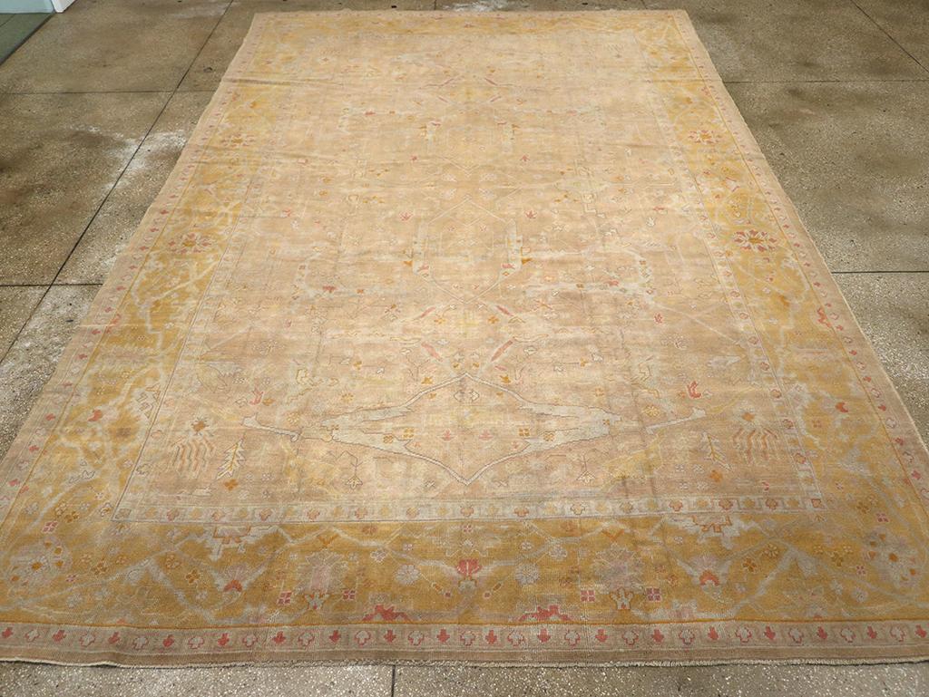An antique Turkish Oushak room size carpet handmade during the Early 20th century.

Measures: 9' 4