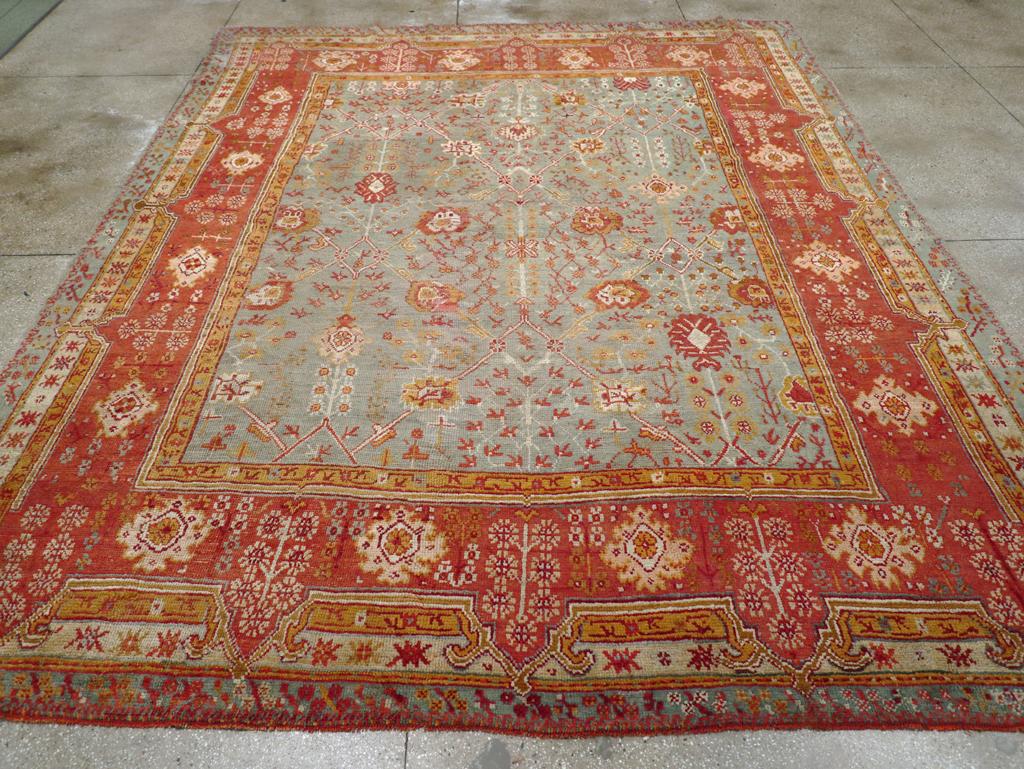 A Wool pile with symmetric knots on a wool foundation. The seafoam blue field features an allover large lattice with slender ivory diagonals, anchored by an assortment of medium-scale palmettes, and discreetly filled in with upright and broken