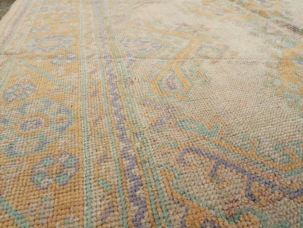 Hand-Knotted Early 20th Century Turkish Oushak Room Size Carpet For Sale