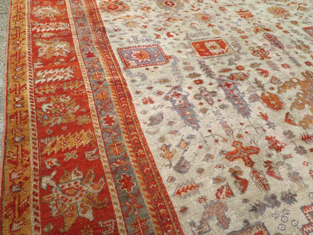 Hand-Knotted Early 20th Century Turkish Oushak Room Size Carpet For Sale