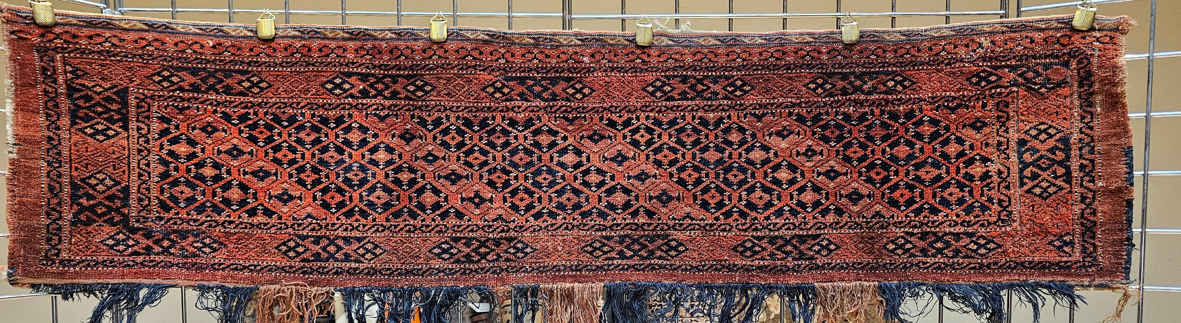 Extremely rare and highly collectable early 20th century Turkmen Ersari Tent Hanging hand woven rug from the Turkmen tribes of Central Asia.  The Turkmen Ersari wall hanging is in a geometric stripe pattern in dark red with accent colors in French