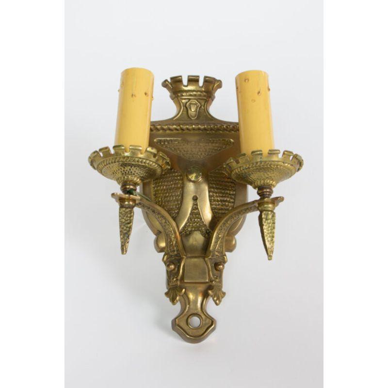 Two arm sconce, cast bronze. Shield form.

Material: Broze
Style: Gothic, Traditional
Place of Origin: United States
Period made: Early 20th Century
Dimensions: 8 × 4 × 10 in
Condition Details: Excellent Condition, Completely restored and