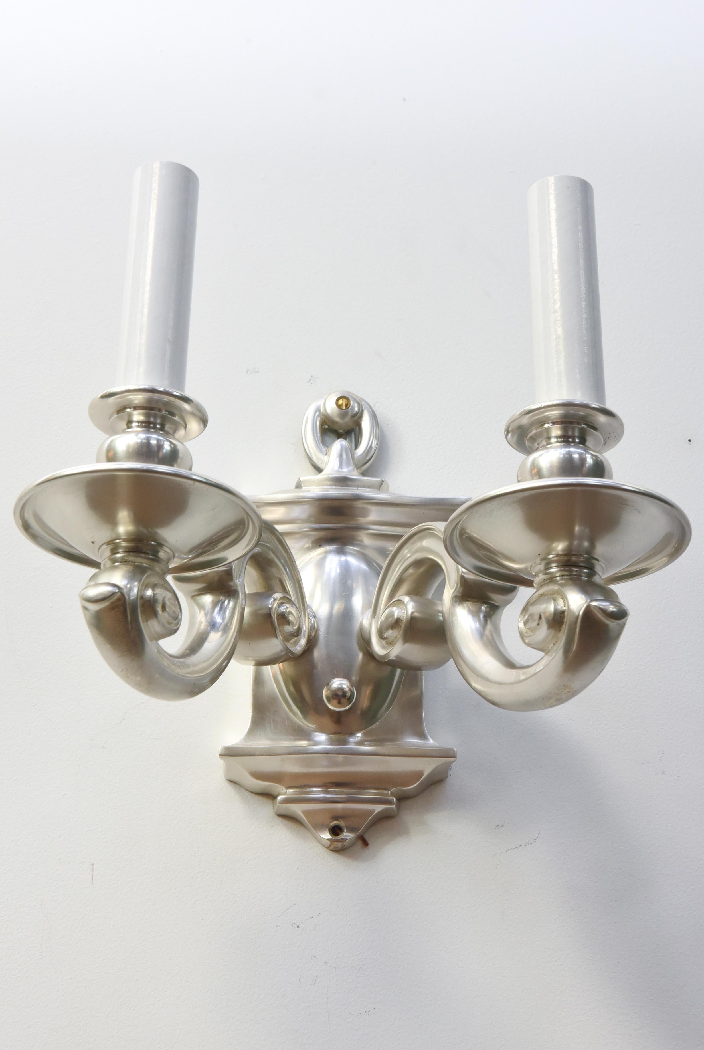 Heavy silver sconces with two arms. Rounded rococo style. American, C. 1910. Have been polished, protected, and rewired. ready for installation.