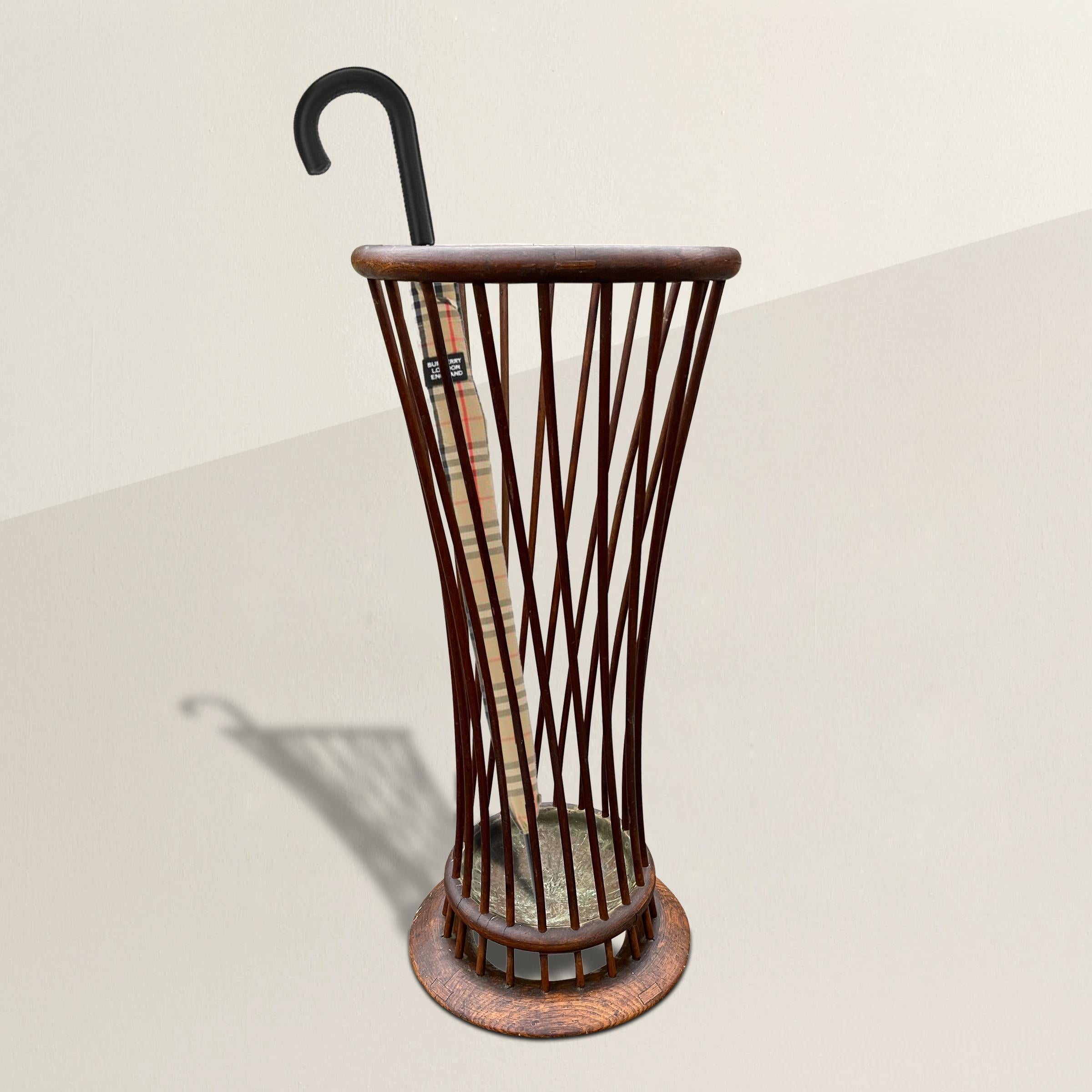 An incredibly chic early 20th century, possibly Viennese Secession, umbrella stand with a bentwood rim supported by multiple twisting spindles, a copper tray, and a bentwood foot. Perfect for umbrellas or walking sticks.