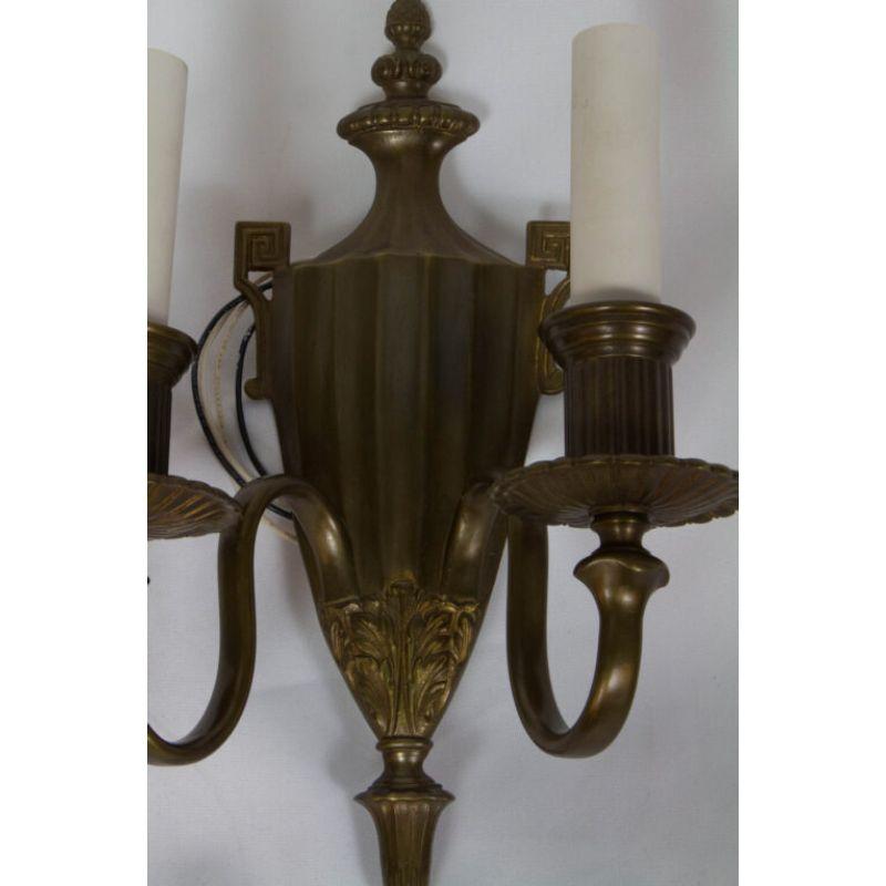 Urn Form Sconces with Porcelain Candlecovers, Set of Eight. Early electric sconces. completely restored and rewired, ready to install. Fine cast bronze. Marked England. England, C. 1910

Dimensions: 
Width: 9.5?
Depth: 4.5?
Height: 14?.