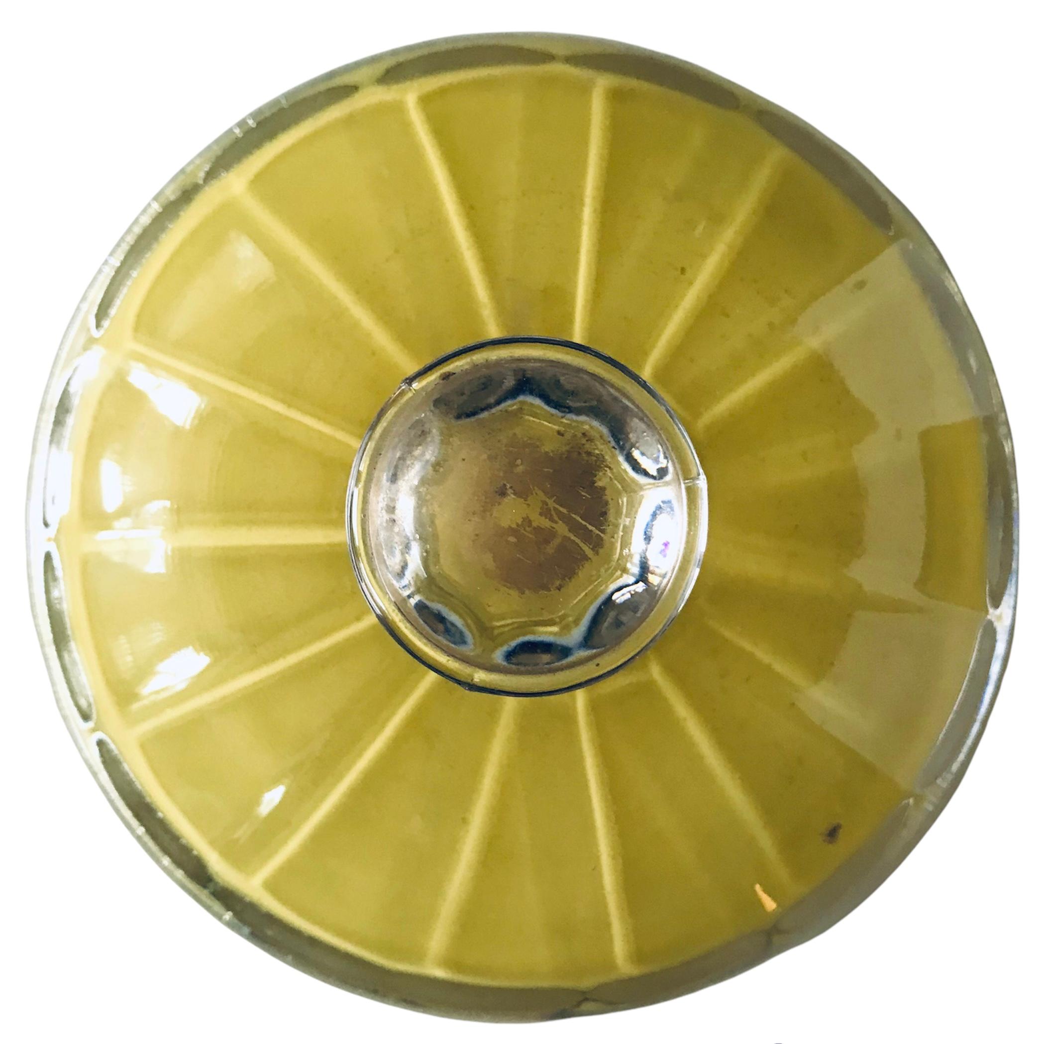 Stunning Early 20th Century Vaseline Glass Candy dish. The hand-blown dish displays a yellow ribbed body with a handsome thick black and thin gold rings on a clear glass pedestal base.